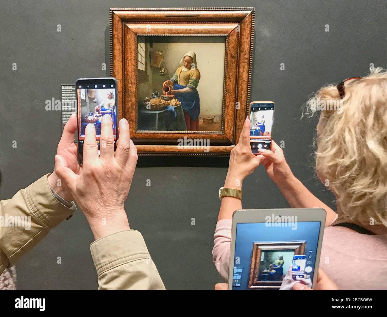 Jan Vermeer's painting The Milkmaid in the Rijksmuseum in Amsterdam is a visitor magnet. Stock Photo