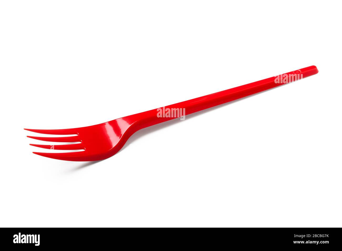 Red plastic disposable fork isolated on white background Stock Photo