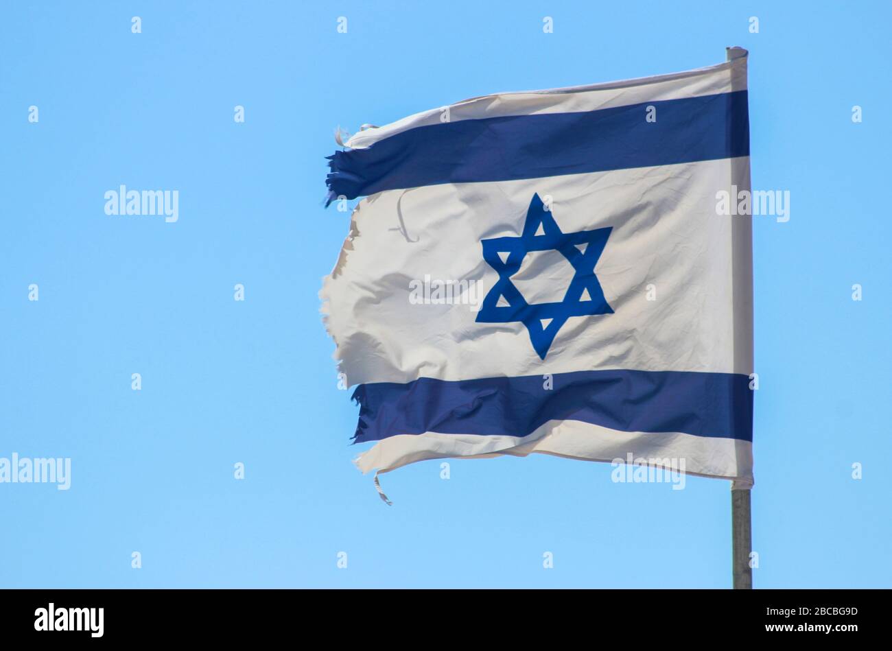 Flag of Israel fluttering in the wind against a blue sky Stock Photo ...