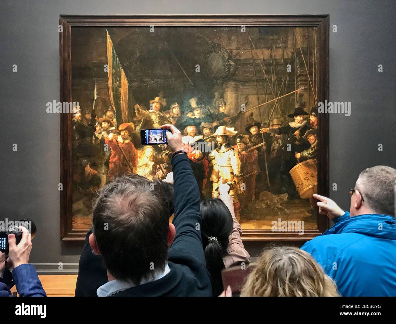 Rembrandt van Rijn's painting Night Watch in the Rijksmuseum in Amsterdam is a visitor magnet. Stock Photo