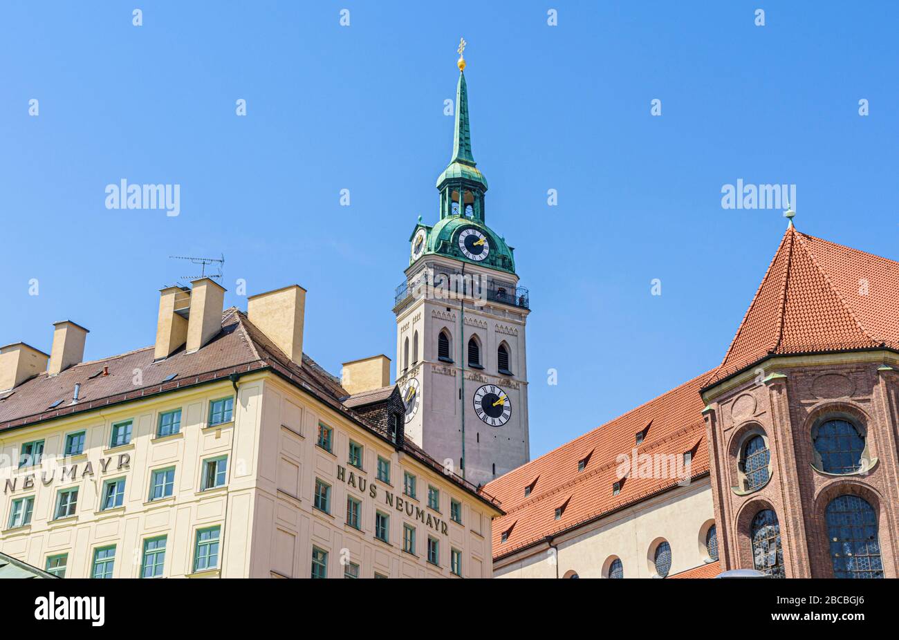 St. Peters Church clock tower overlooking the old town buildings in the centre of Munich, Germany Stock Photo