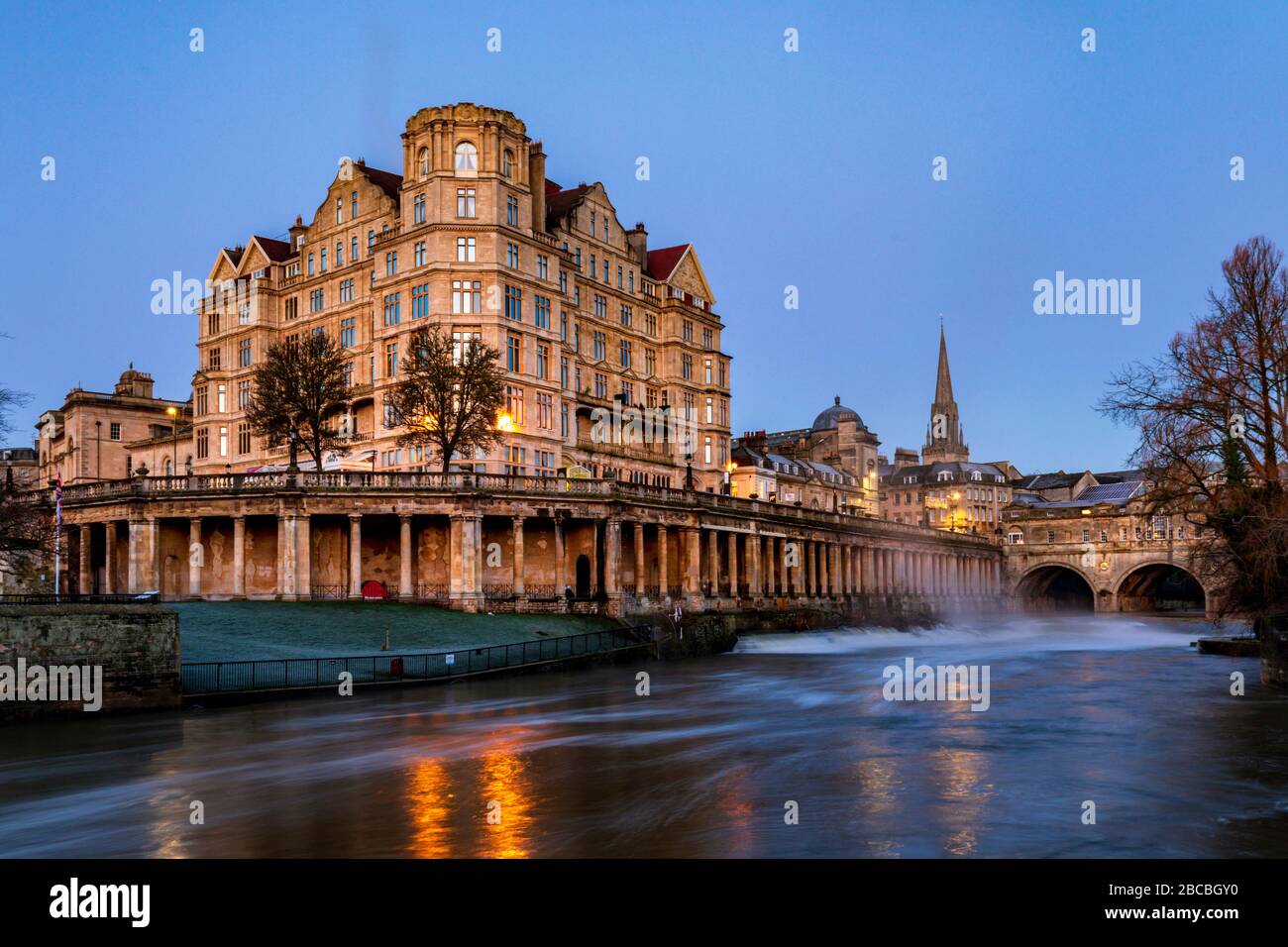 The Empire Hotel near Pulteney Bridge with the Colonnade under Newmarket Row and the Pulteney weir on the River Avon, Bath, England Uk Stock Photo