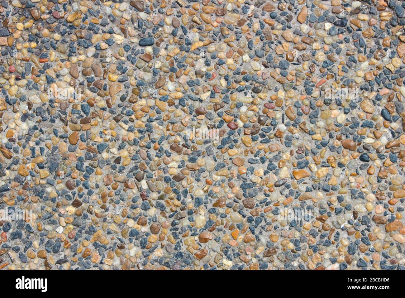 Stone surface covered with small pebbles as background Stock Photo