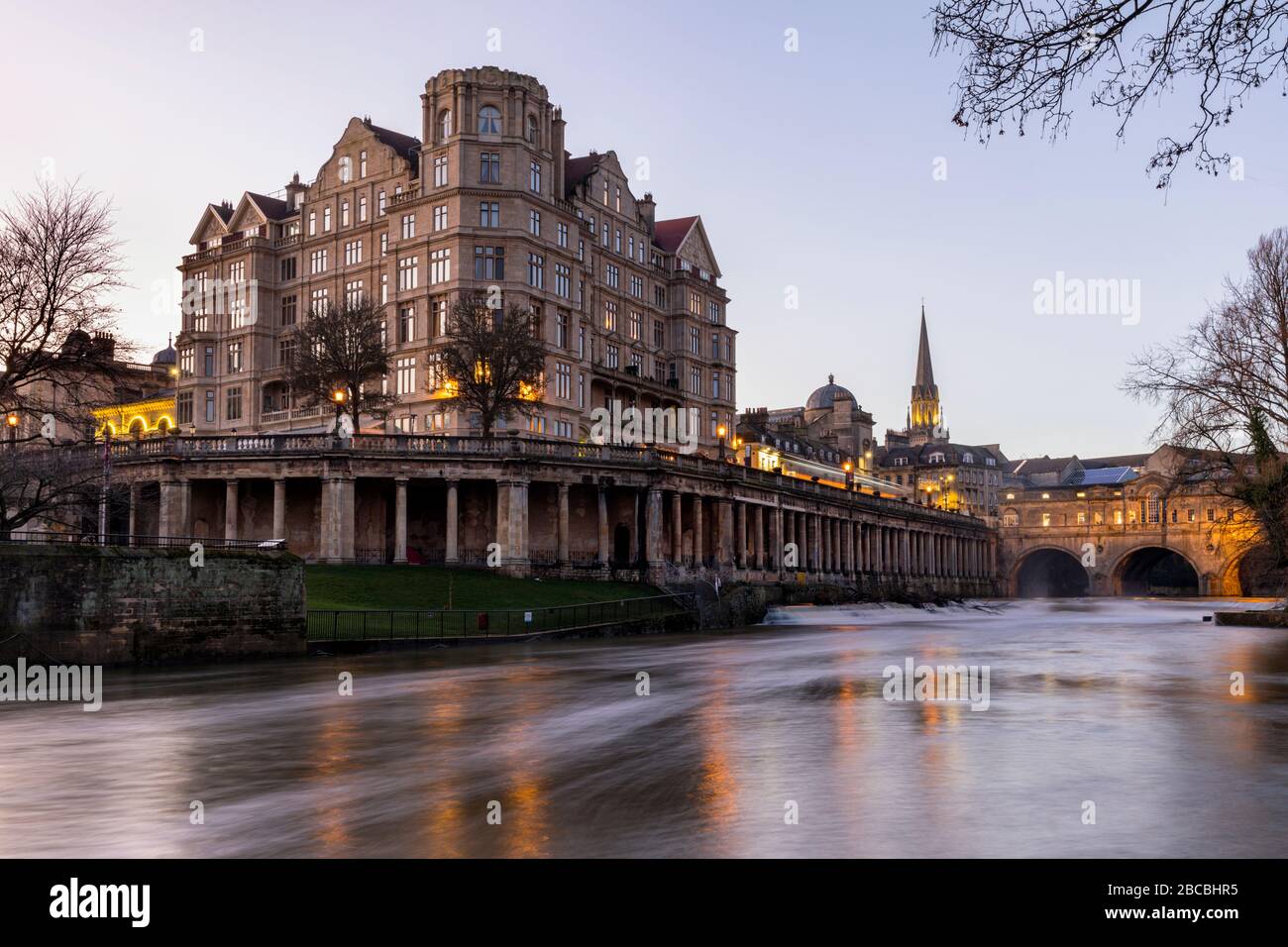 The Empire Hotel near Pulteney Bridge with the Colonnade under Newmarket Row and the Pulteney weir on the River Avon, Bath, England Uk Stock Photo