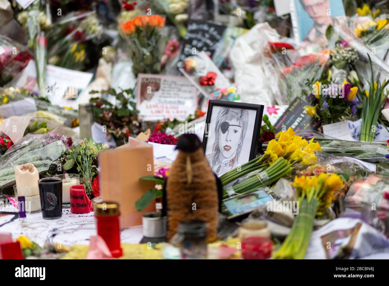 Detail of memorial offerings laid beside the David Bowie mural in Brixton just after his death, London Stock Photo