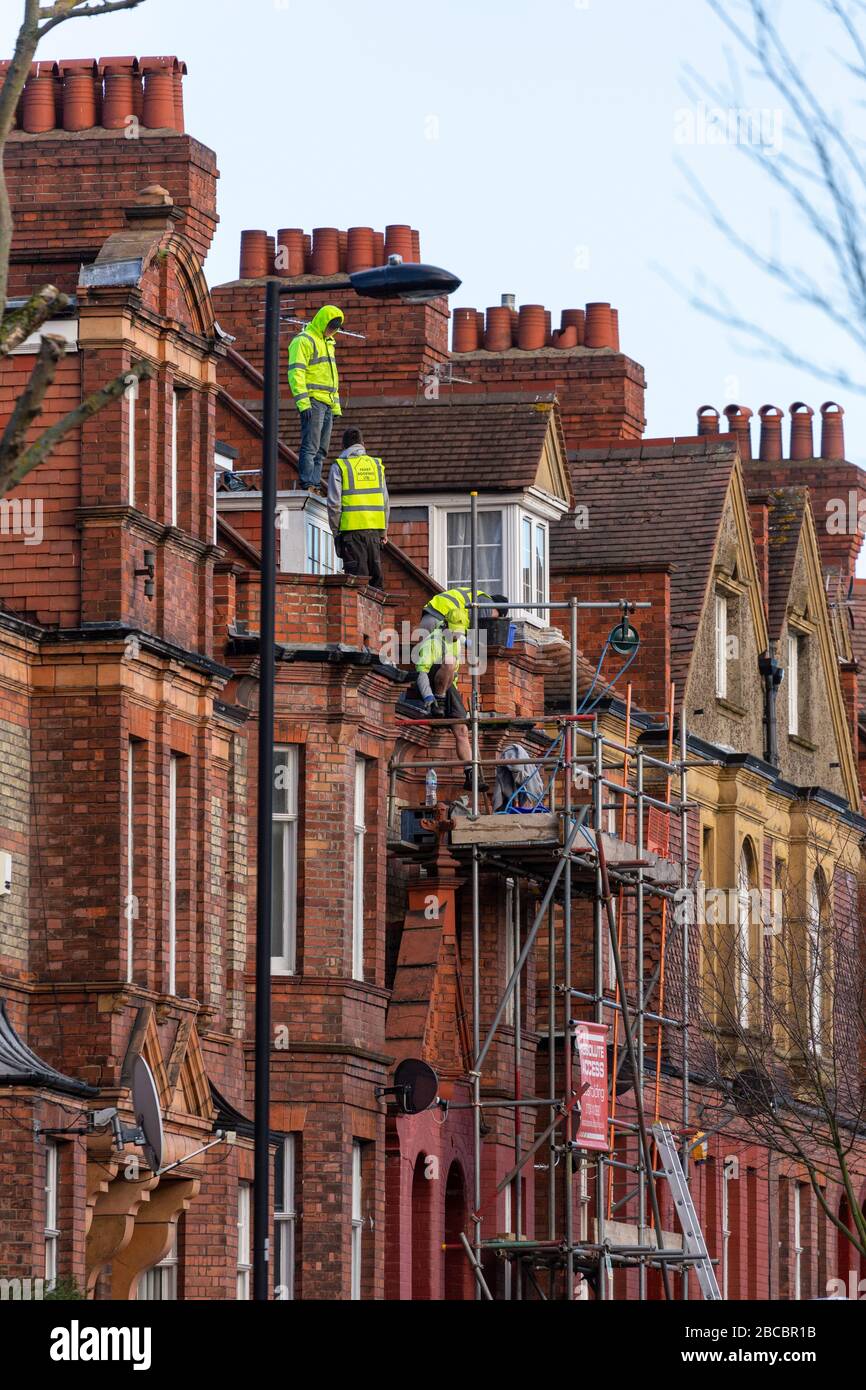Workers on scaffolding on Amesbury Ave, Streatham Hill, London Stock Photo