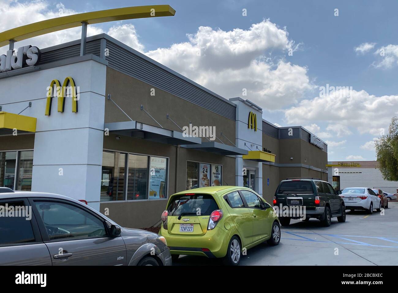 Cars wait in line at McDonald's restaurant drive thru amid the global ...