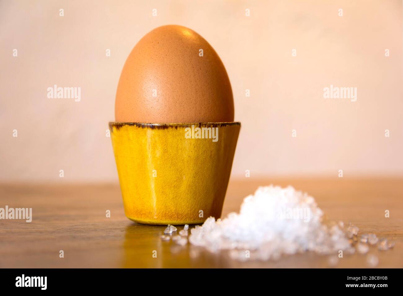 Eggcup with salt, ceramic. Stock Photo