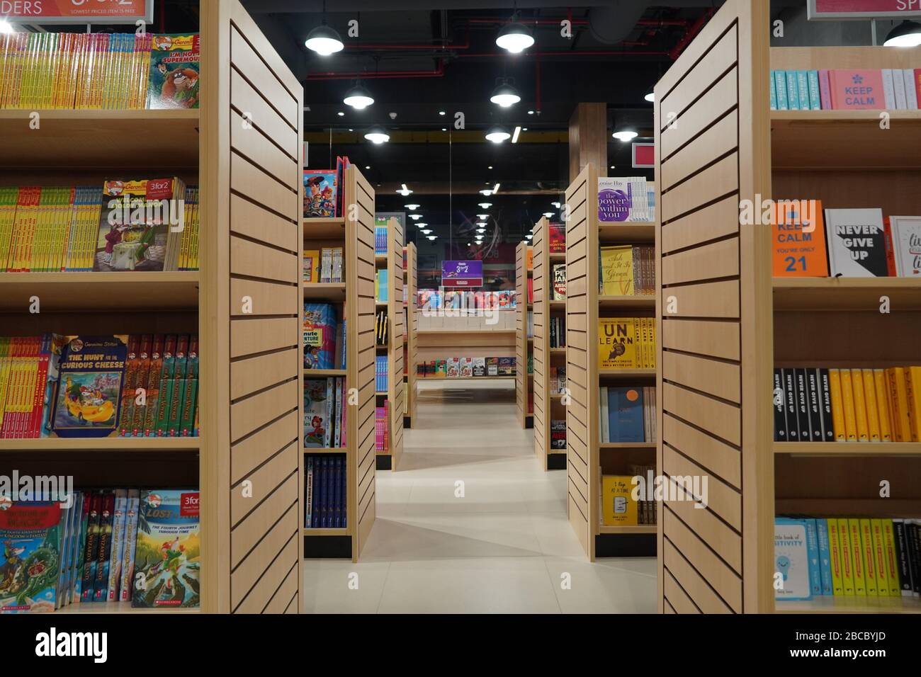 Aisle between shelves of library books, in an education background like