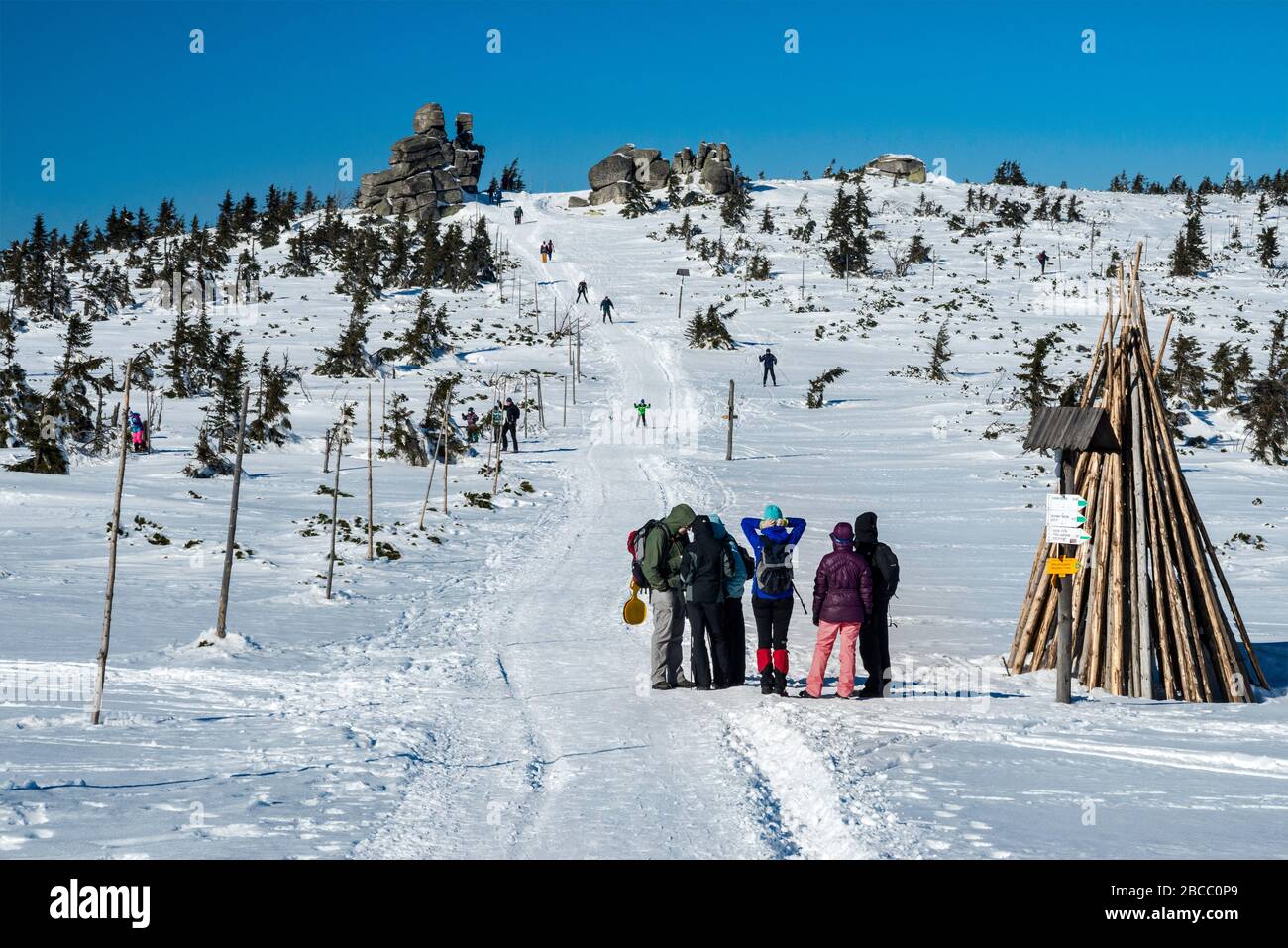 Hikers in winter on trail, running along Polish-Czech border, subalpine plateau, main ridge in Karkonosze National Park, Lower Silesia, Poland Stock Photo