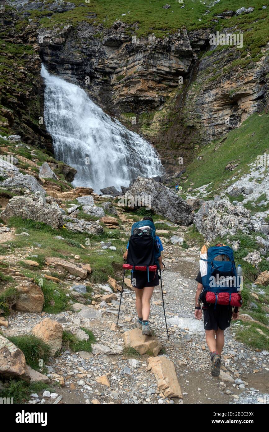 Trekkers approaching to “ Cola de caballo” (ponytail) waterfall.Ordesa National Park.Huesca.Aragon.Spain Stock Photo