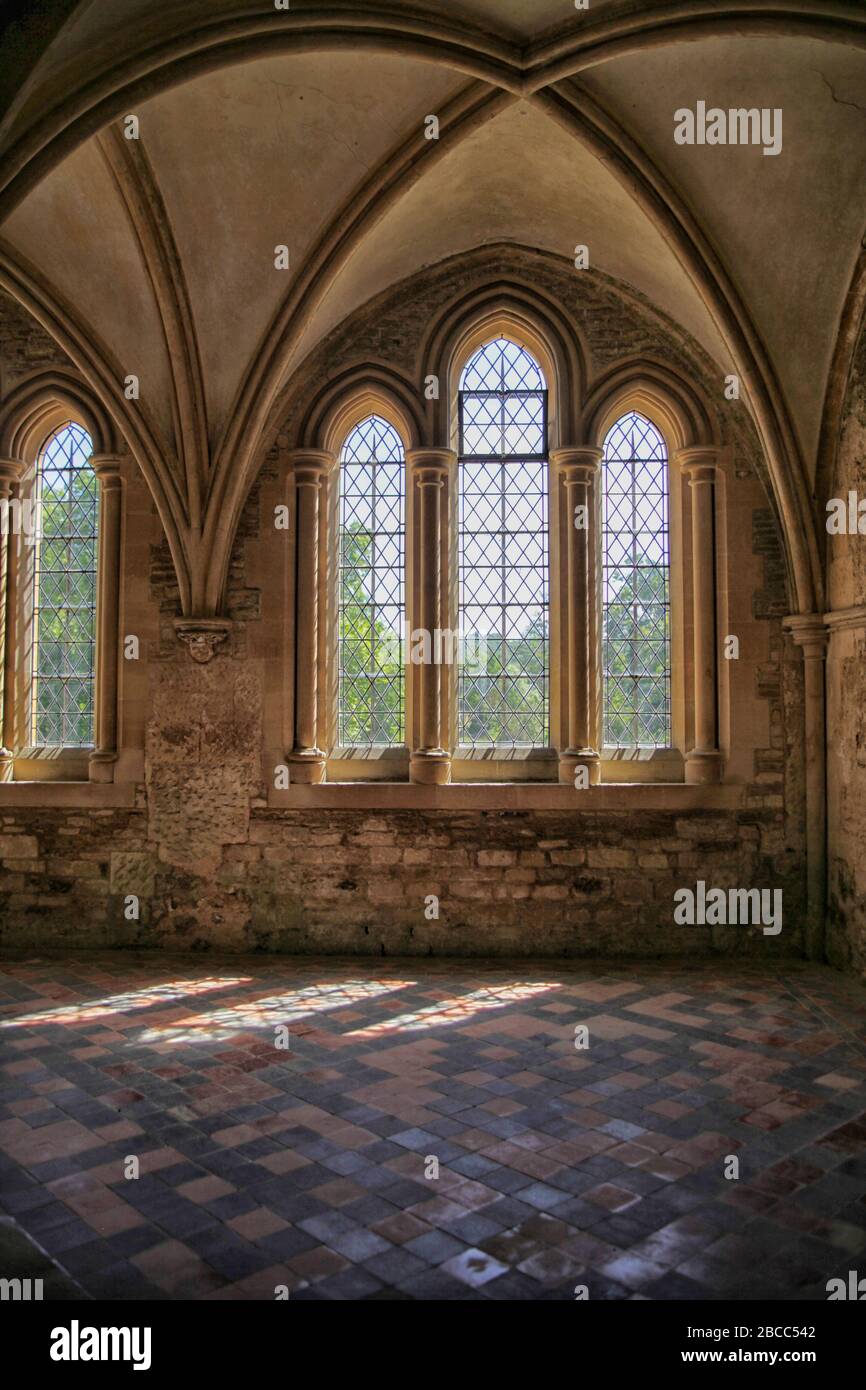 Sun shining through gothic windows in the medieval abbey of Lacock, Wiltshire Stock Photo