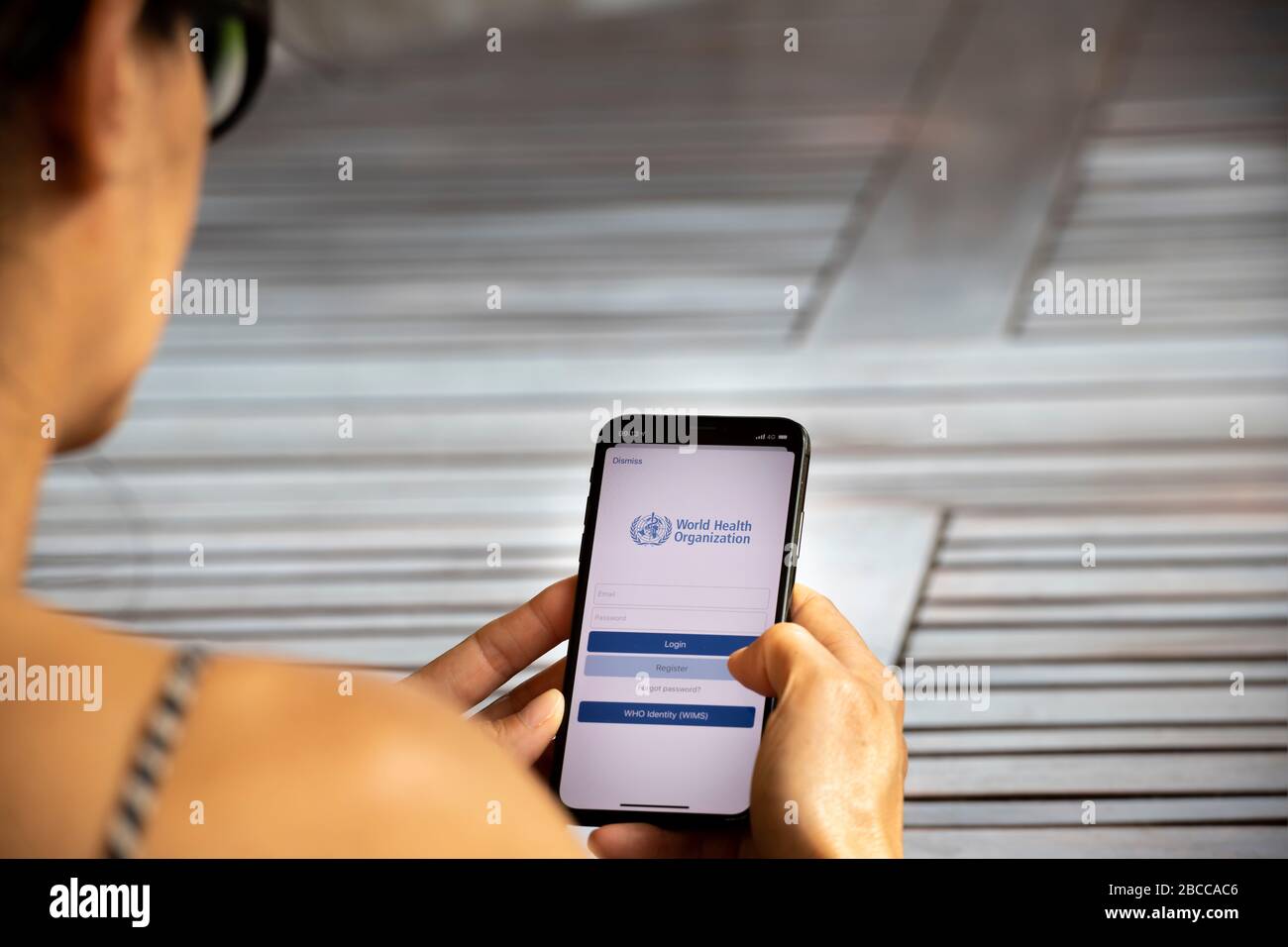 Woman registering on the World Health Organization application on her smartphone Stock Photo