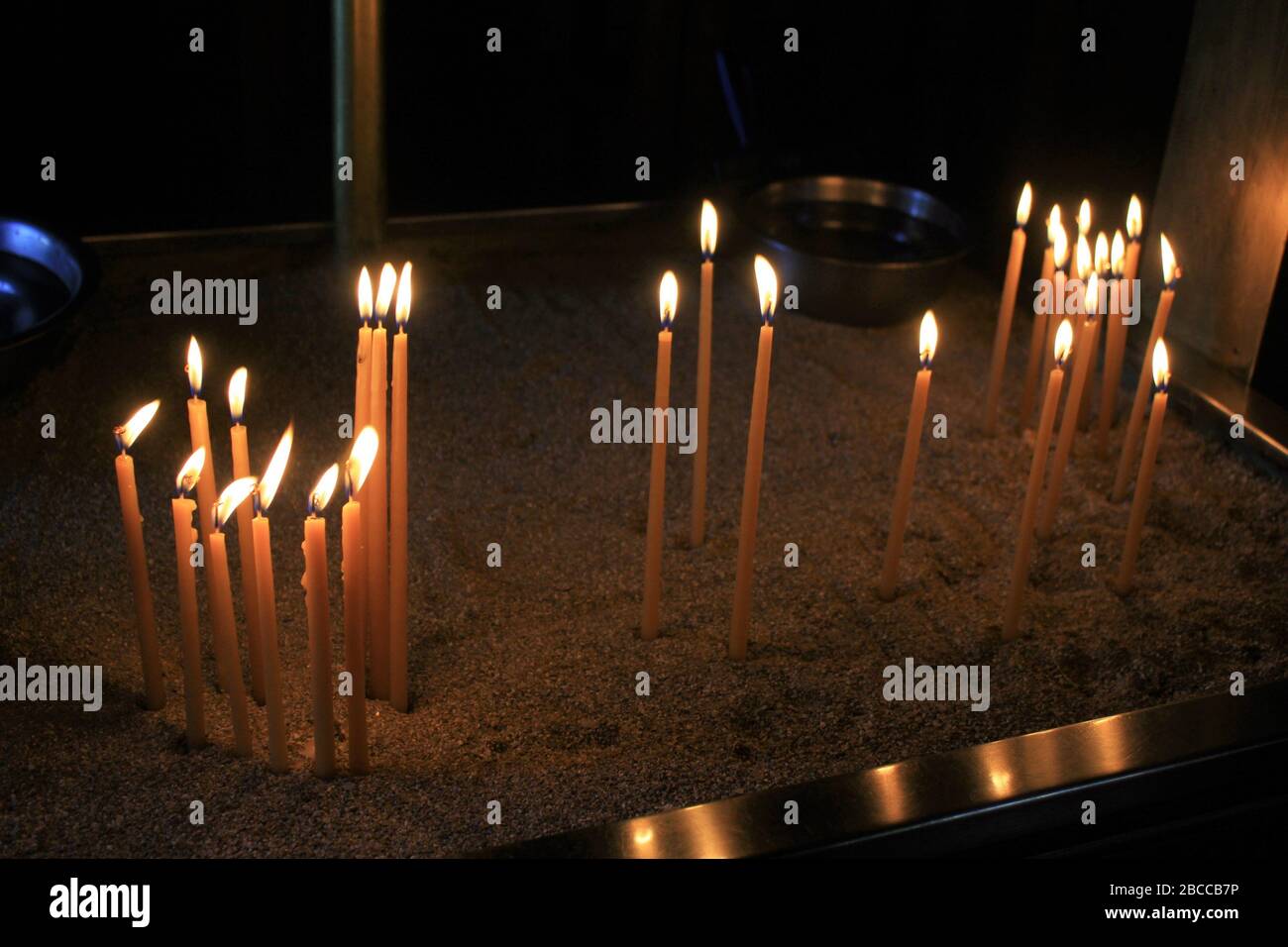 Lighting candles inside a Greek orthodox church Stock Photo Alamy