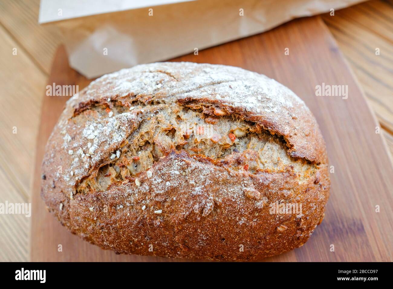 Carrot bread on a cutting board. Uncut loaf of bread. Homemade, eco