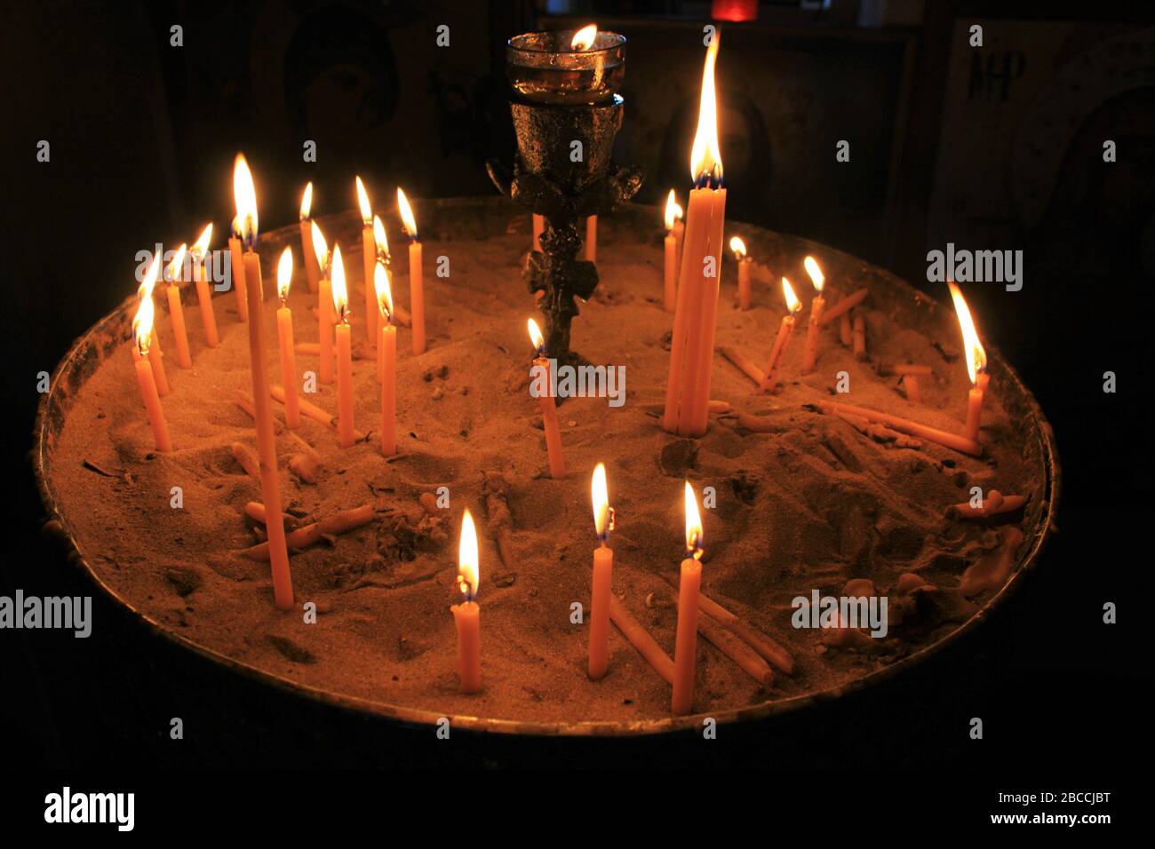 Lighting candles inside a Greek orthodox church Stock Photo Alamy