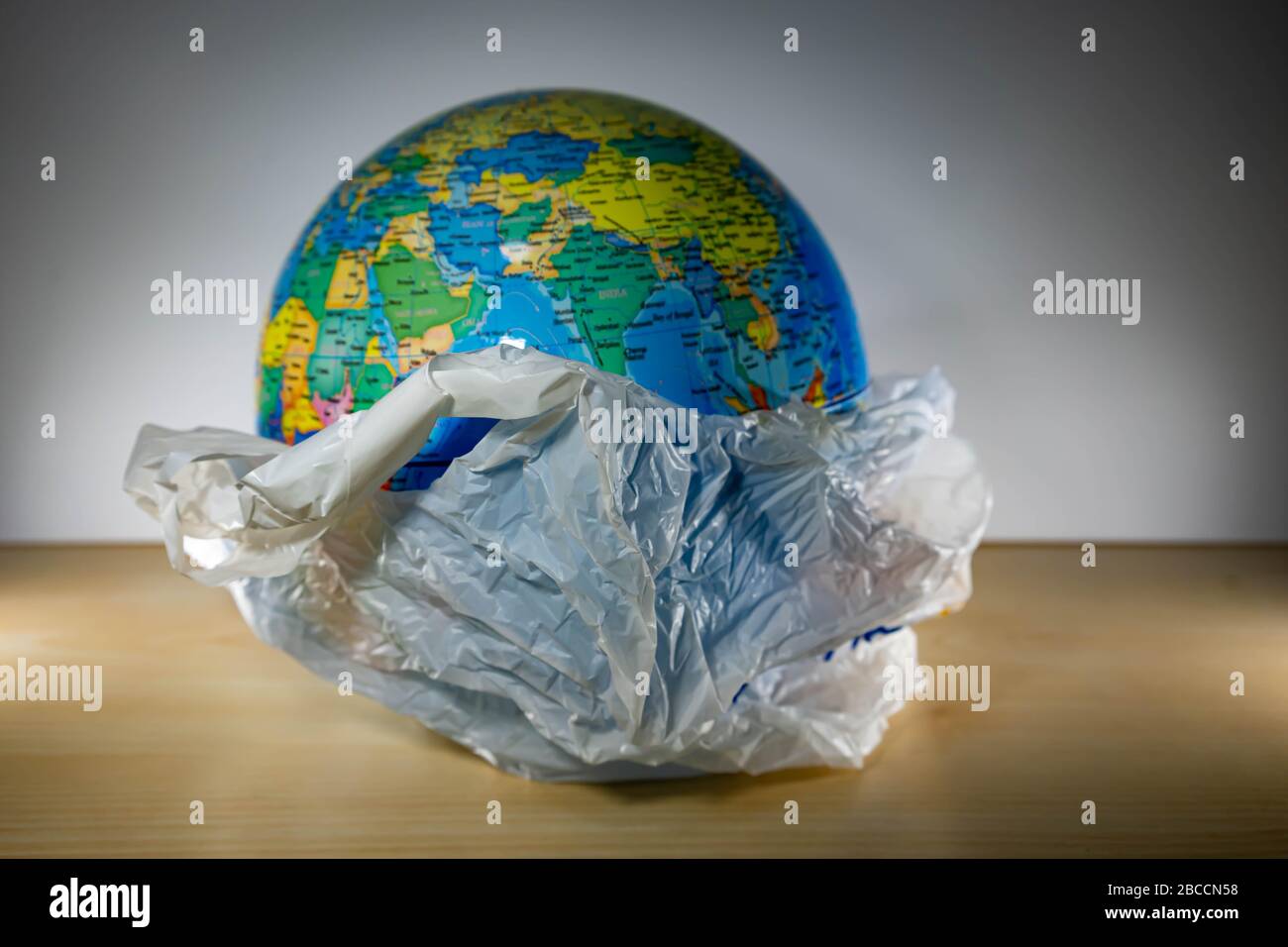 Grocery Plastic with earth inside. Earth is being destroyed because of too much garbage like plastic Stock Photo