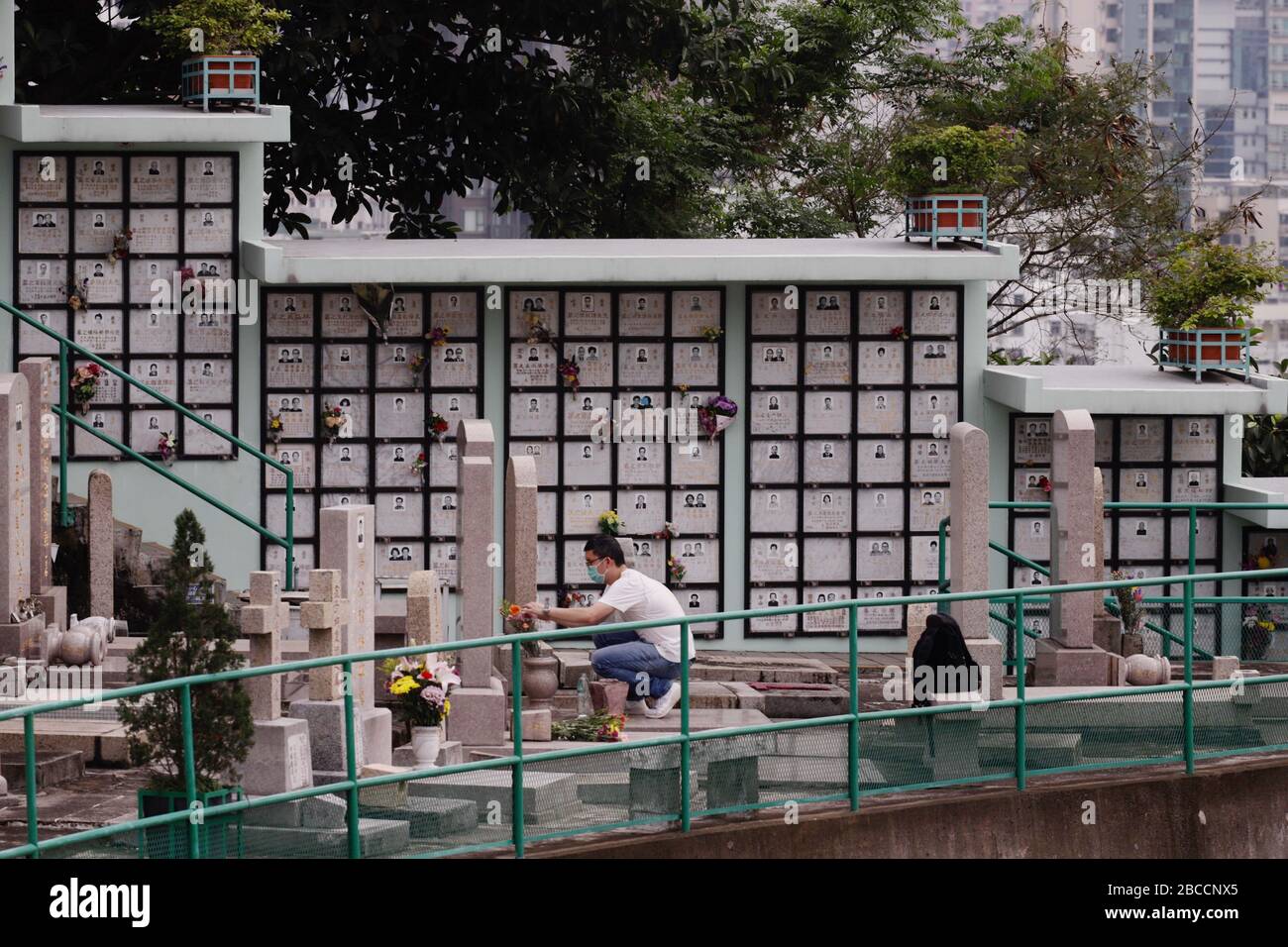 April 4, 2020, Hong Kong, CHINA: Lone man decorate his ancestral grave with flowers at the cemetery. Today mark the CHING MING FESTIVAL, an essential annual tradition diligently observed by Chinese, to 'sweep the grave' by remembering and honoring the ancestors. This year, numbers of visitors to the graveyards have dropped significantly since HK government have issued an order prohibiting congregation of more than 4 person in the public places in order curb spreading of coronavirus infections in the City.April-4, 2020 Hong Kong.ZUMA/Liau Chung-ren (Credit Image: © Liau Chung-ren/ZUMA Wire) Stock Photo