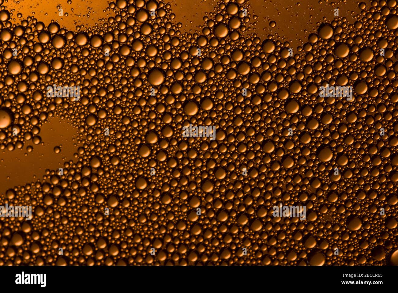 Yellow orange water drops background. Soft focus Stock Photo
