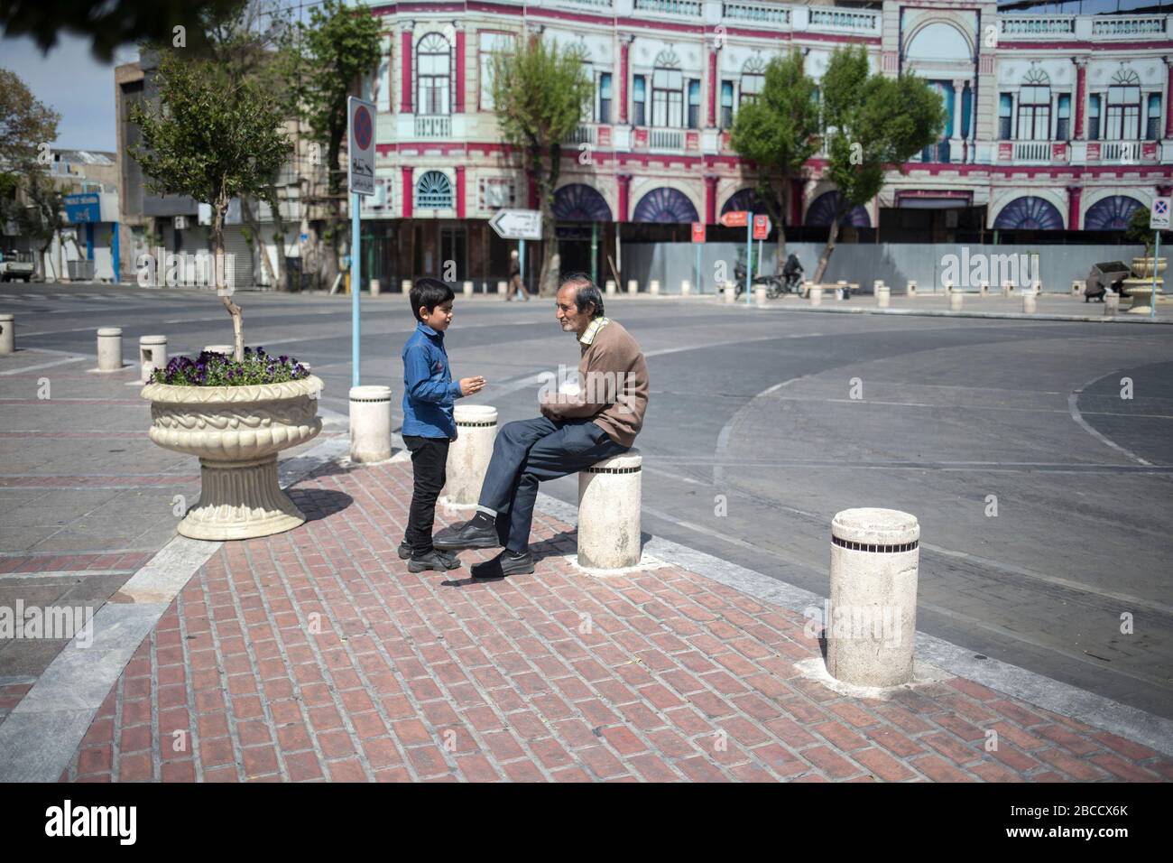 Iran. 3rd Apr, 2020. Photo taken on April 3, 2020 shows a man and his son at an empty street in Tehran, Iran. The number of confirmed cases of COVID-19 in Iran reached 55,743 on Saturday, with an increase of 2,560 in the past 24 hours, according to the latest figure from Iran Ministry of Health and Medical Education. Credit: Ahmad Halabisaz/Xinhua/Alamy Live News Stock Photo