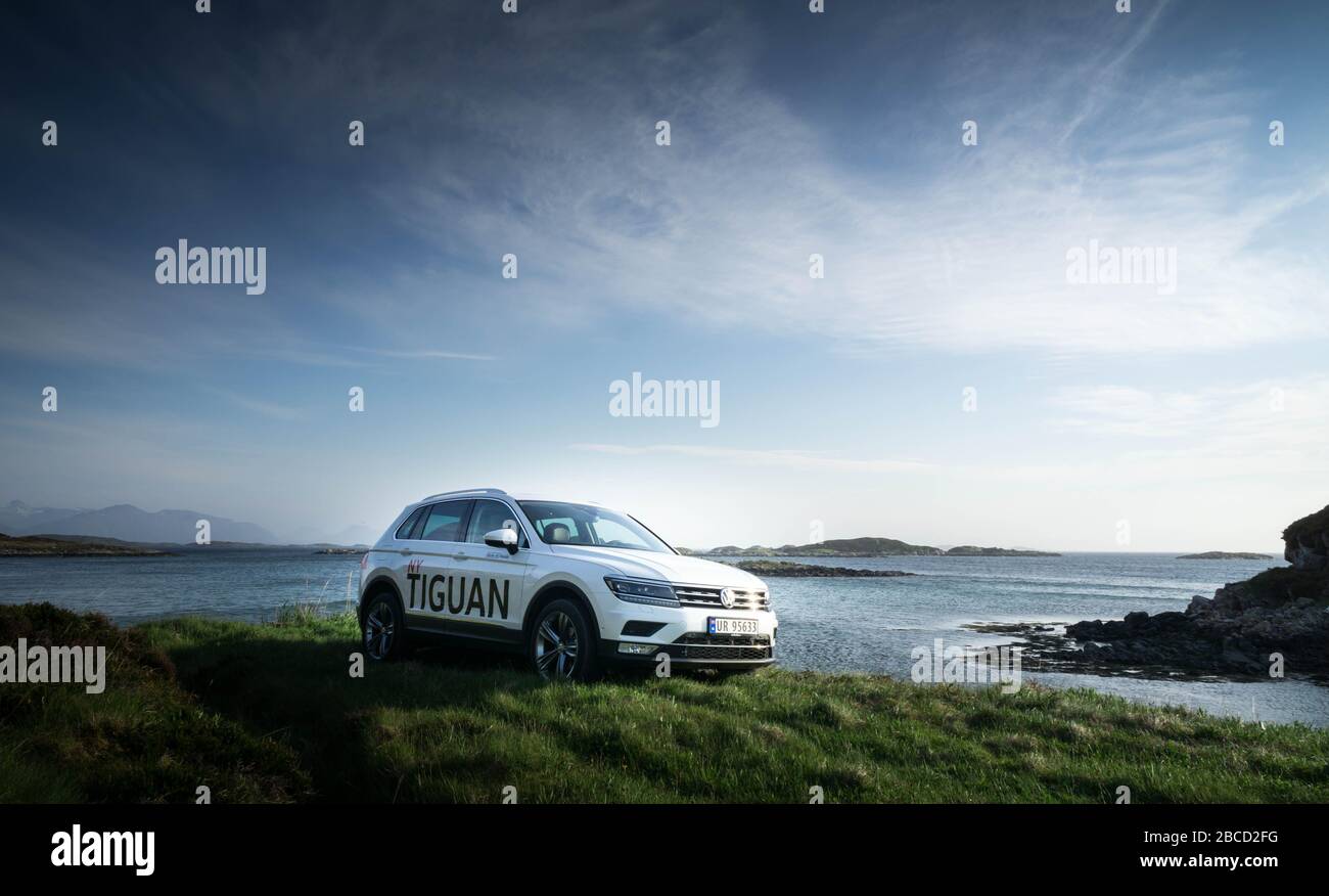 VW Tiguan at sunset by the ocean Stock Photo