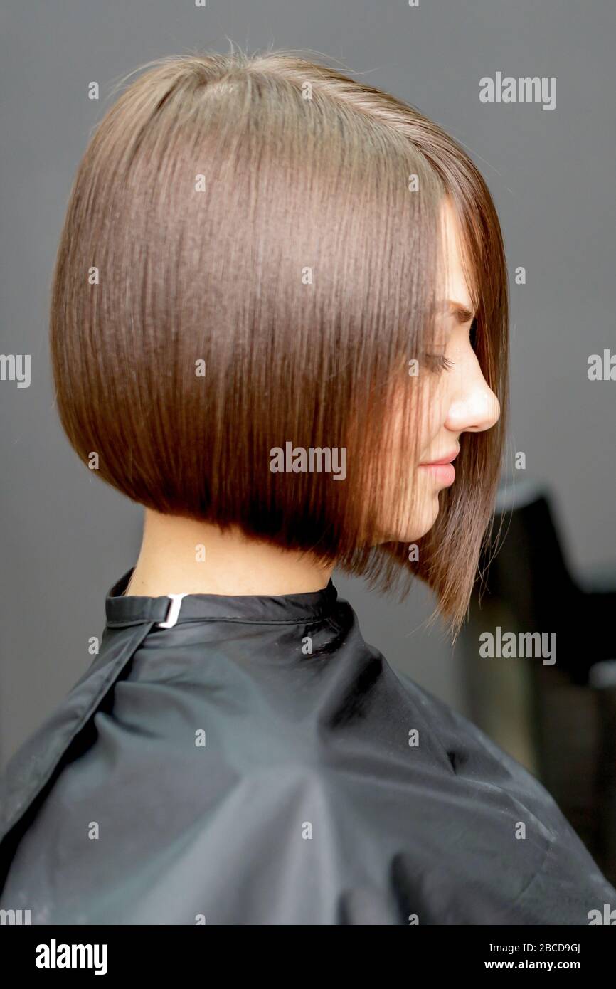 Woman with short hairstyle in hair salon with copy space. Toned Stock Photo  - Alamy