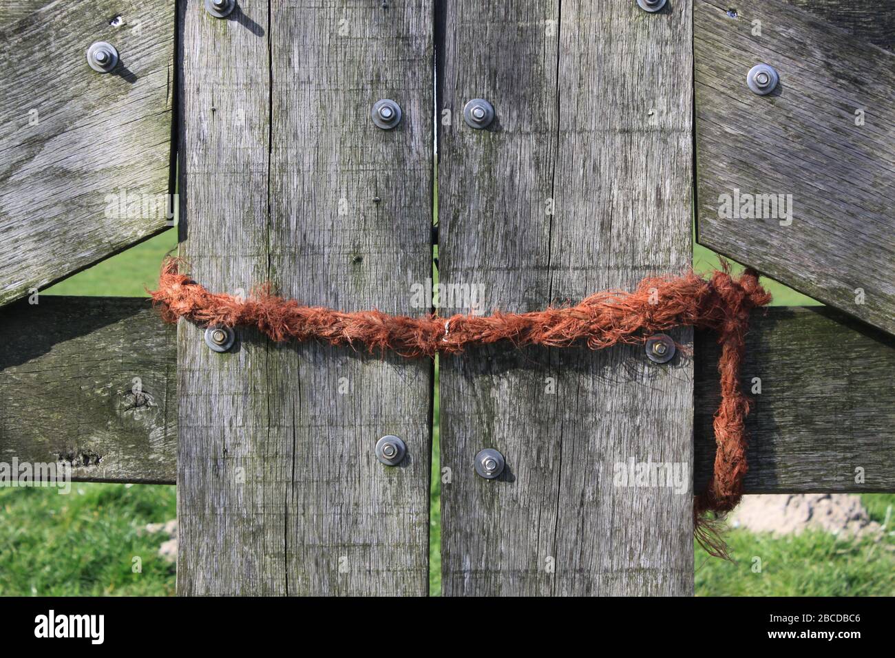 Wooden fence of a farm with orange rope around it no access Stock Photo