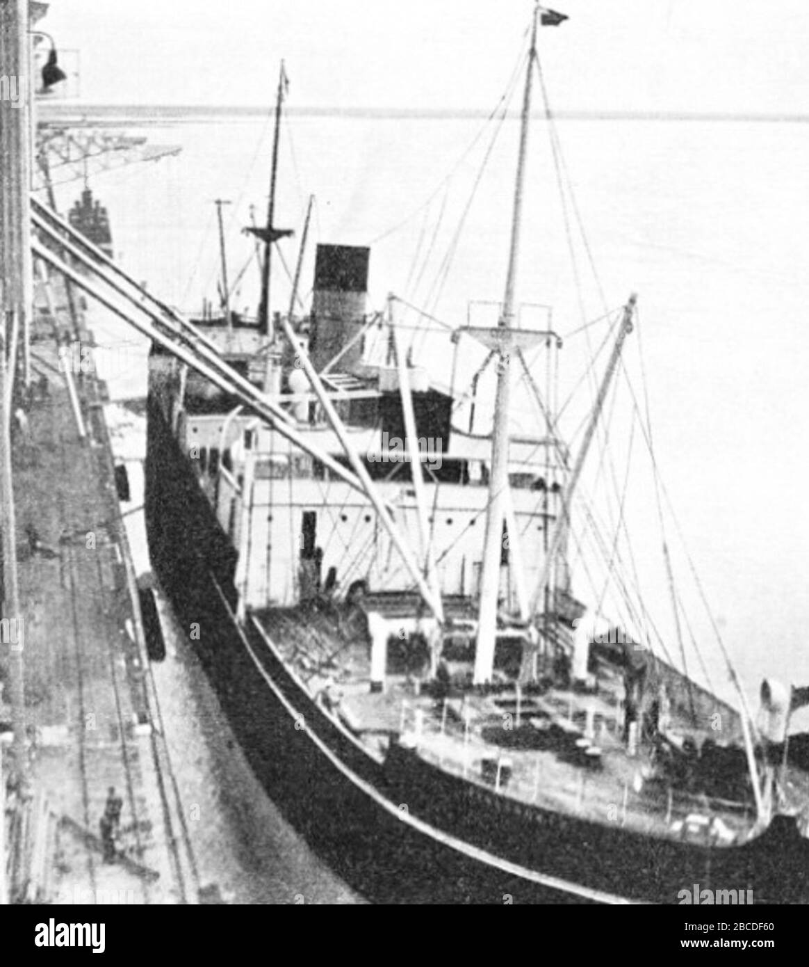 'Pennyworth in Churchill, 1933.  Original caption:  ONE OF THE FIRST GRAIN CARGOES to be loaded at Churchill went into the Pennyworth. When her holds had been cleared and the necessary shifting boards erected in them, the long pipe-arms were swung from the grain elevator and the grain began to pour in. About 8,000 tons of grain were loaded on this occasion.; 1933; http://www.shippingwondersoftheworld.com/churchill.html; Unknown author; ' Stock Photo