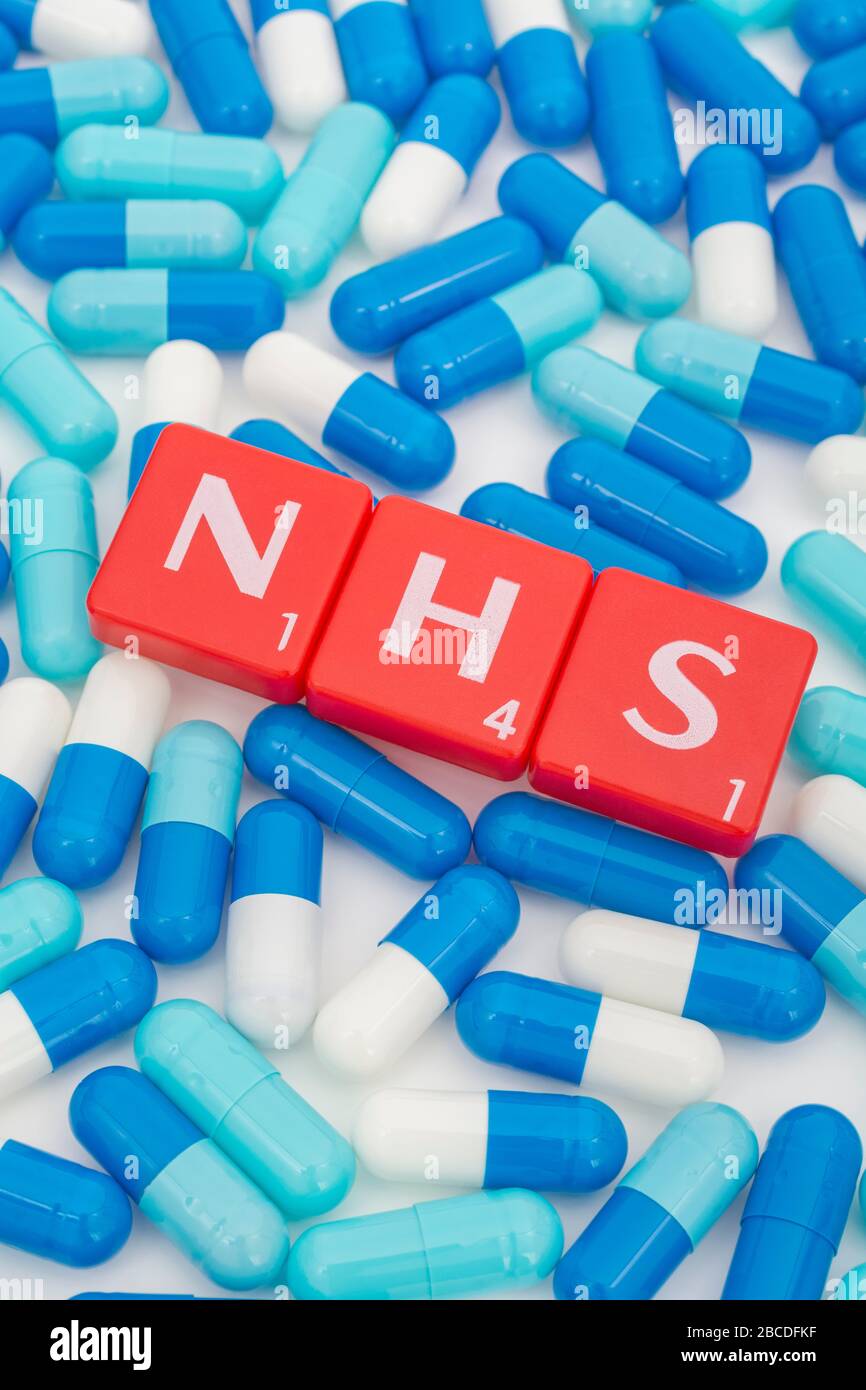 NHS letters tiles & assorted blue pills. Metaphor NHS in Covid 19 pandemic, NHS heroes, NHS prescriptions, UK National Health Service, medicine in UK Stock Photo