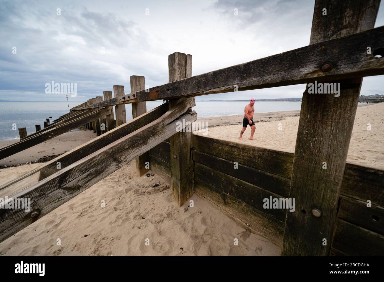 Portobello, Edinburgh, Scotland, UK. 4 April, 2020. On the second weekend of the coronavirus lockdown in the UK, Paul Edwards from Portobello takes his daily allowable outdoor exercise by open water swimming 1400m in the Firth of Forth. Iain Masterton/Alamy Live News Stock Photo