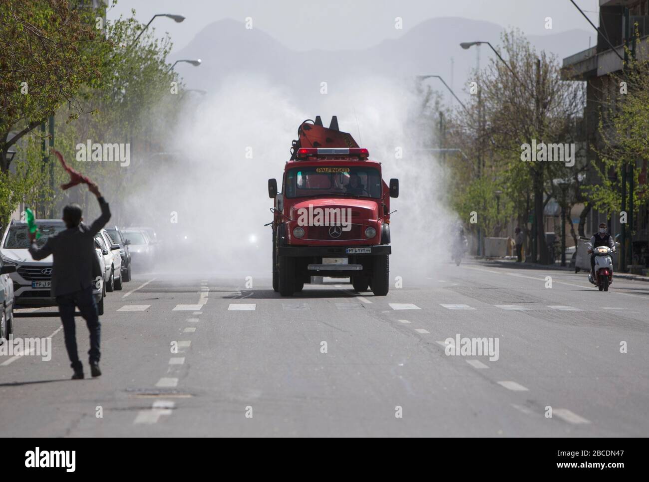Tehran, Iran. 3rd Apr, 2020. A truck disinfects a street in Tehran, Iran, April 3, 2020. The number of confirmed cases of COVID-19 in Iran reached 55,743 on Saturday, with an increase of 2,560 in the past 24 hours, according to the latest figure from Iran Ministry of Health and Medical Education. Credit: Ahmad Halabisaz/Xinhua/Alamy Live News Stock Photo