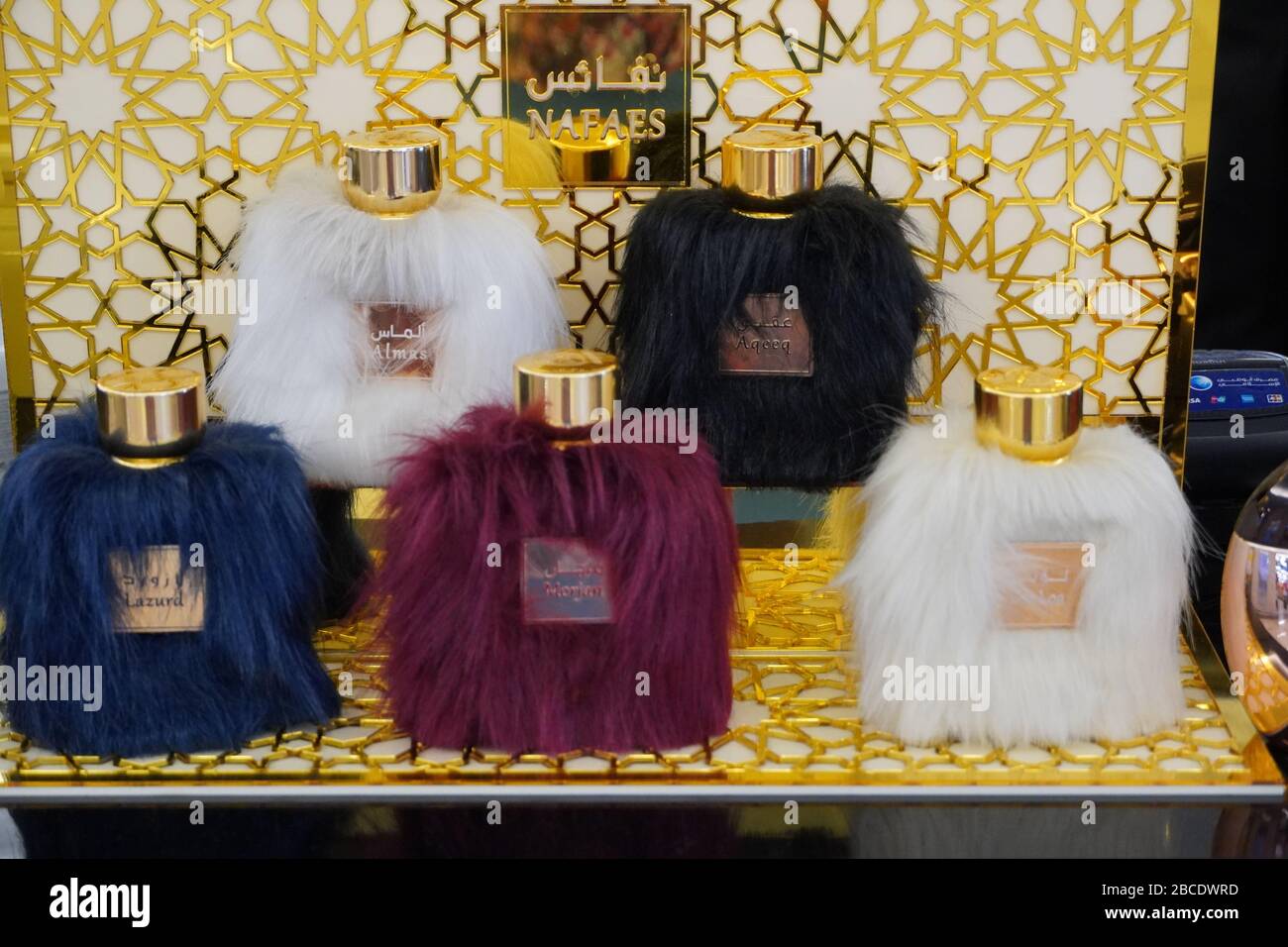 Perfume bottle with fur in different colors. Bottle are covered in