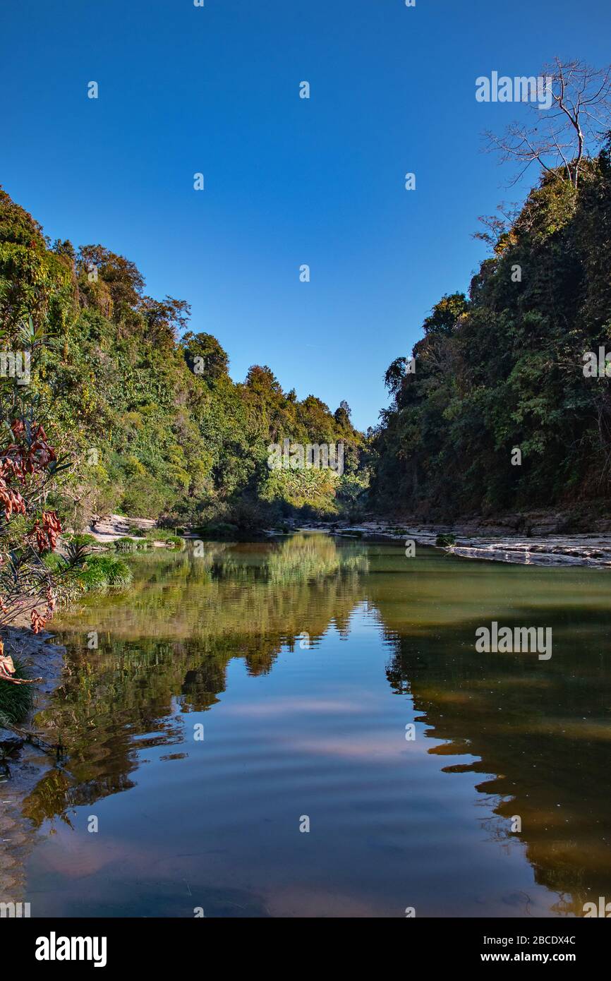 A mesmerizing landscape view of Sangu River flowing between hills. The picture was taken in Remakri, Bandarban. Stock Photo