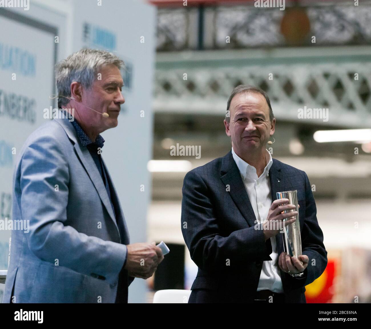 Tiff Needell presenting Jonathan Neal, COO, McLaren Technology Centre, with  the Icon Award, as part of a Special tribute to Bruce McLaren, at the 2020 London Classic Car Show Stock Photo
