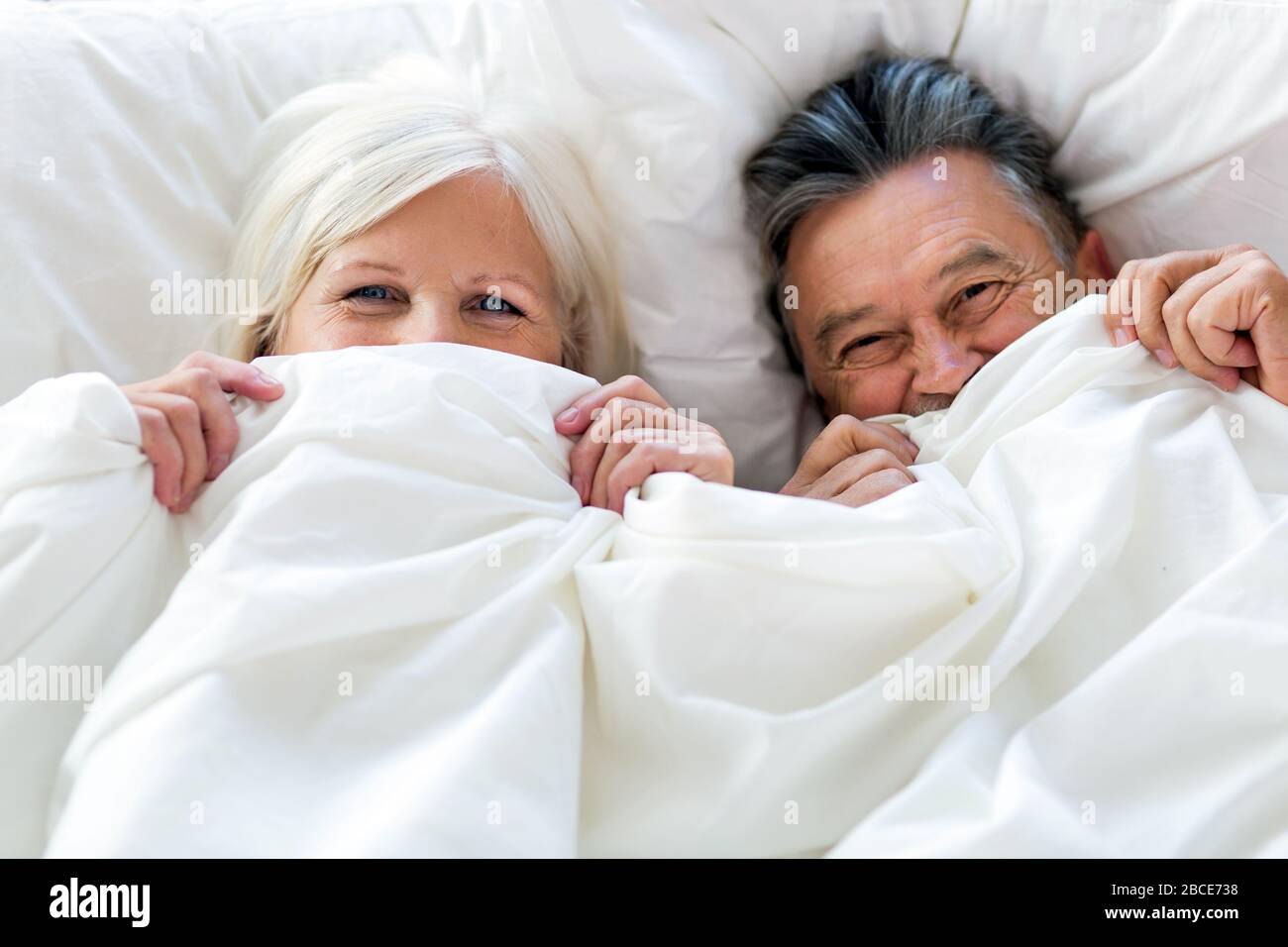 Senior couple in bed together Stock Photo