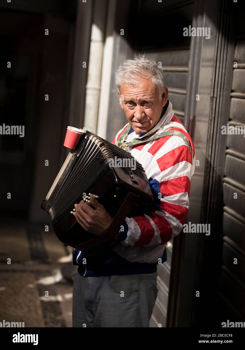 Busker playing accordion in Lisbon Stock Photo