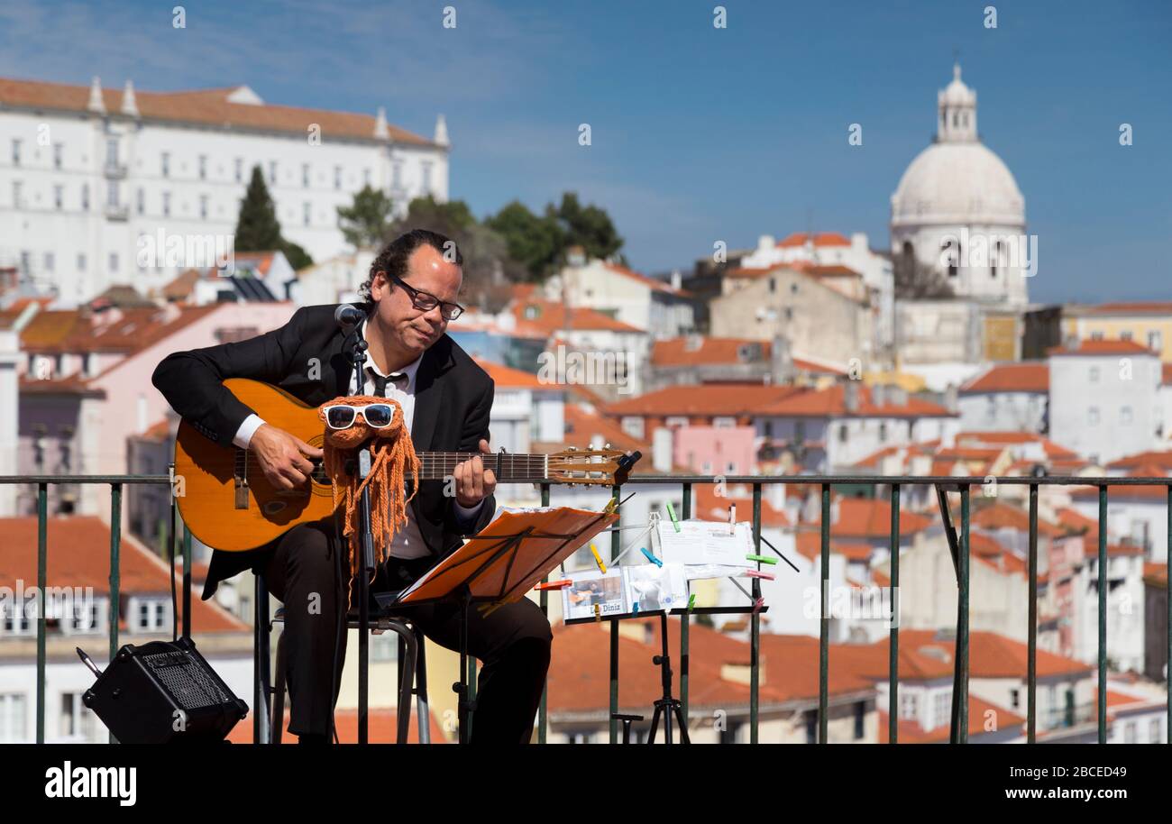 Busker playing guitar at Miradouro das Portas do Sol, Lisbon Stock