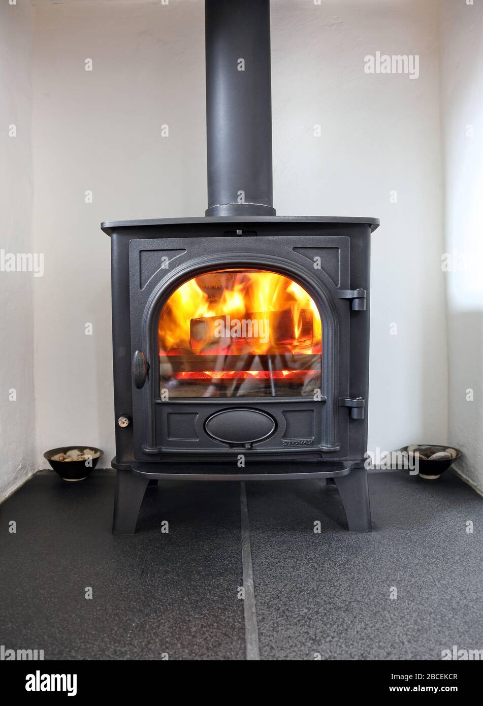 Roaring Fire in a Multi Fuel Stove, UK Stock Photo