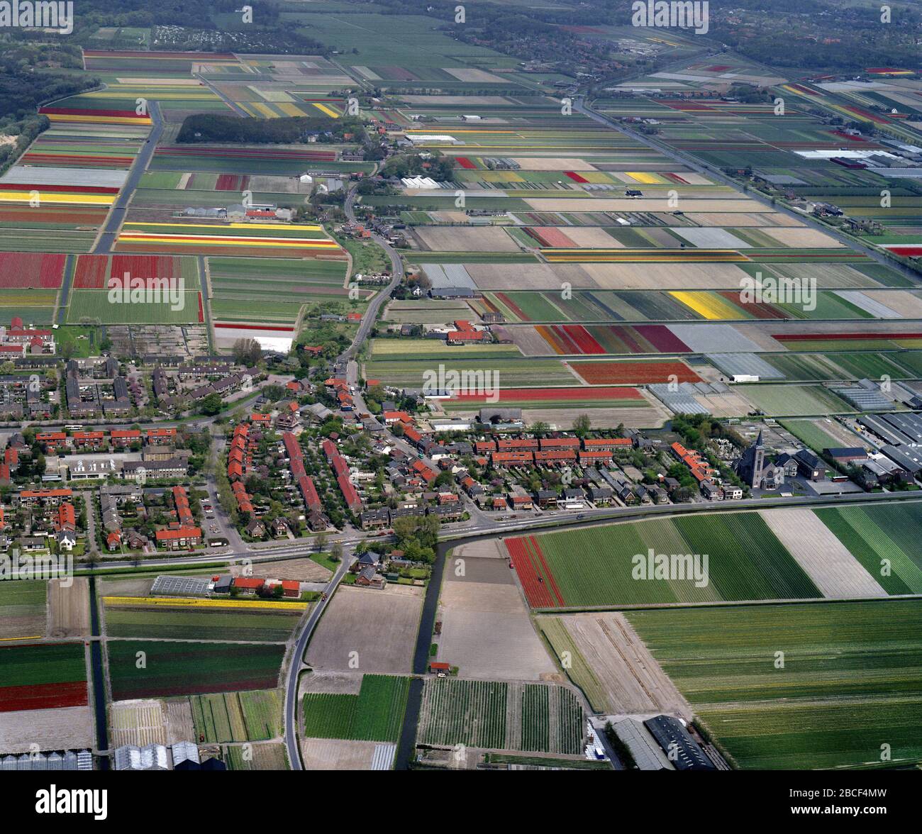 Lisse, Holland, May 12 - 1986: Historical aerial photo of the flower fields near Noordwijkerhout and village De Zilk Stock Photo