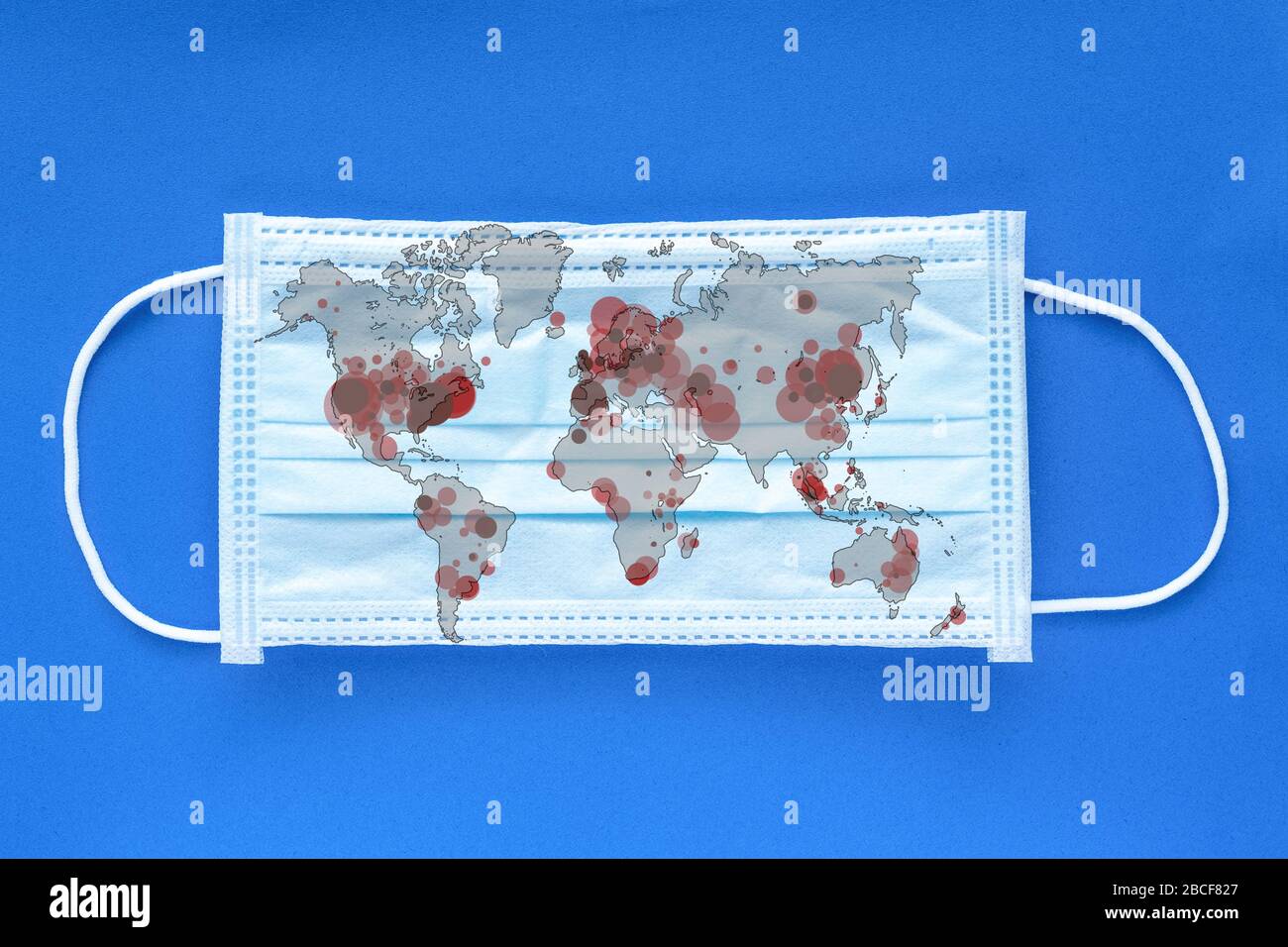World map showing coronavirus infected countries on face mask Stock Photo