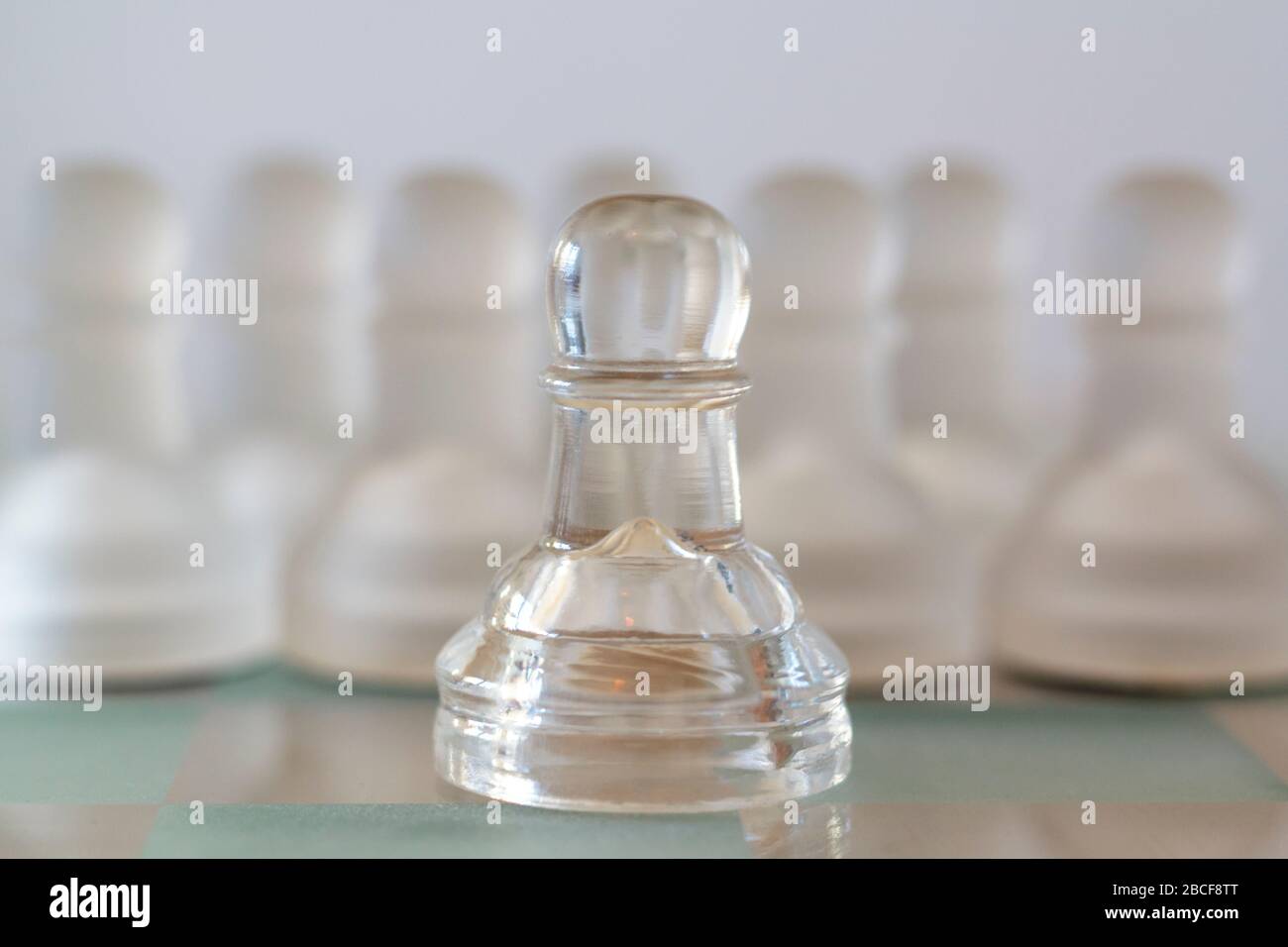 Chess pawn leading a crowd of pawns. Leader inspiration and business influence concept Stock Photo