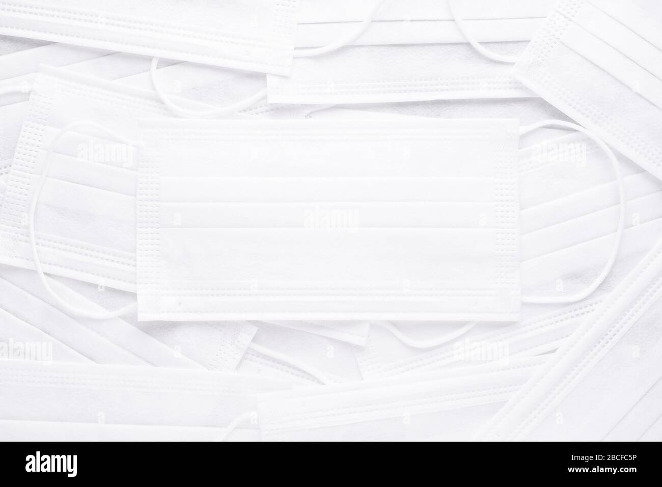 abstract background with many white medical masks, flat lay Stock Photo ...