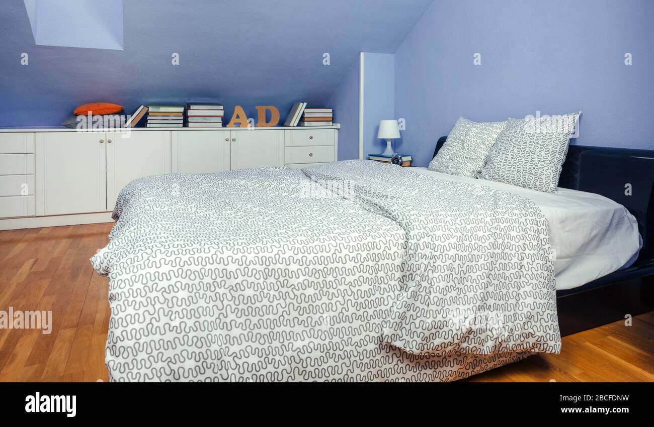 Bedroom in an attic with double bed Stock Photo - Alamy