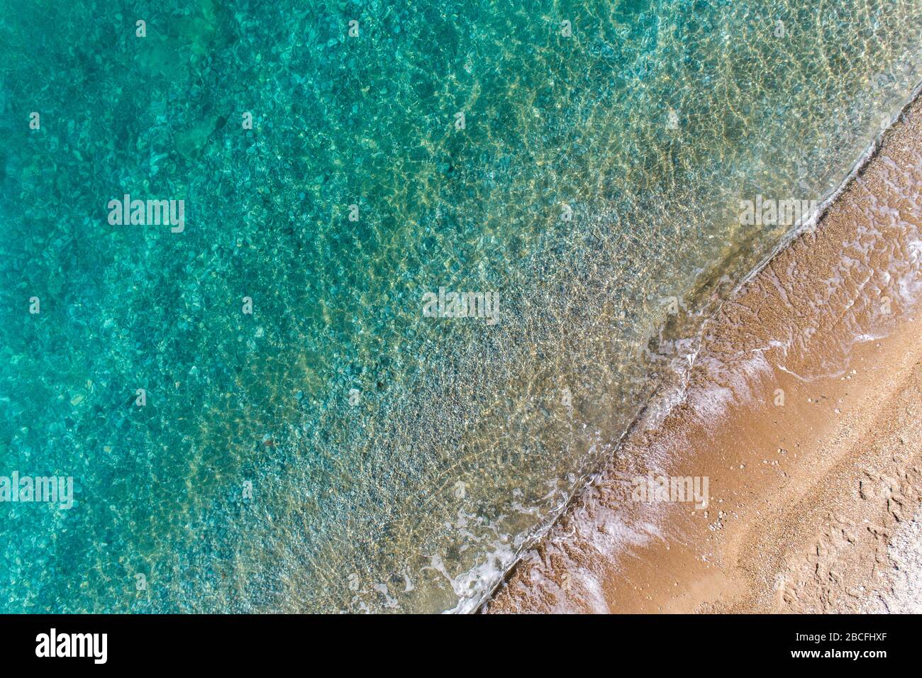 Transparent waves roll on sandy hi-res stock photography and images - Alamy