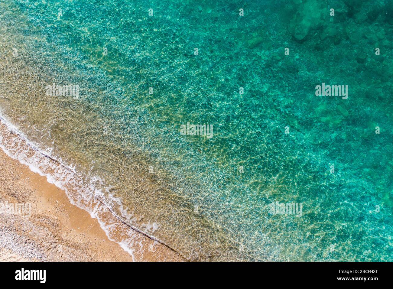 Transparent waves roll on sandy hi-res stock photography and images - Alamy