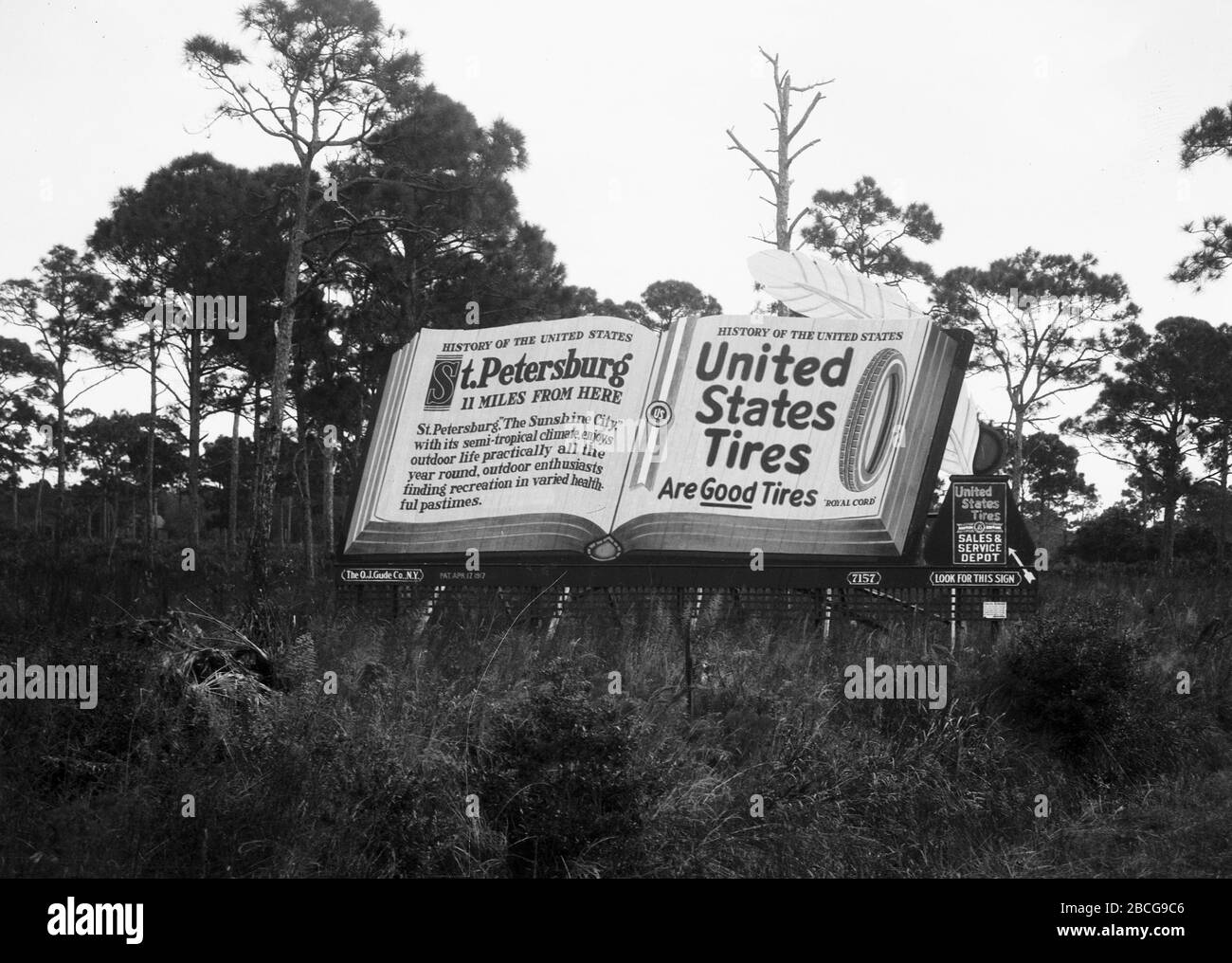 A billboard for United States Tires with a book about United States history open to pages about nearby St. Petersburg and U.S. Tires, Florida, 1920s. (Photo by Burton Holmes) Stock Photo