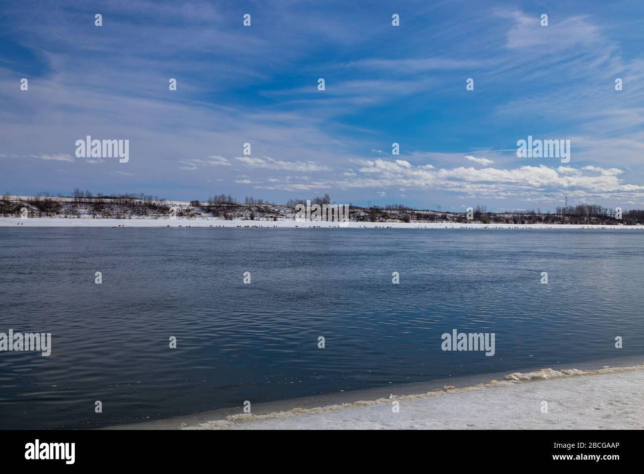 beautiful views of the South Saskatchewan River partially frozen in the early spring season Stock Photo