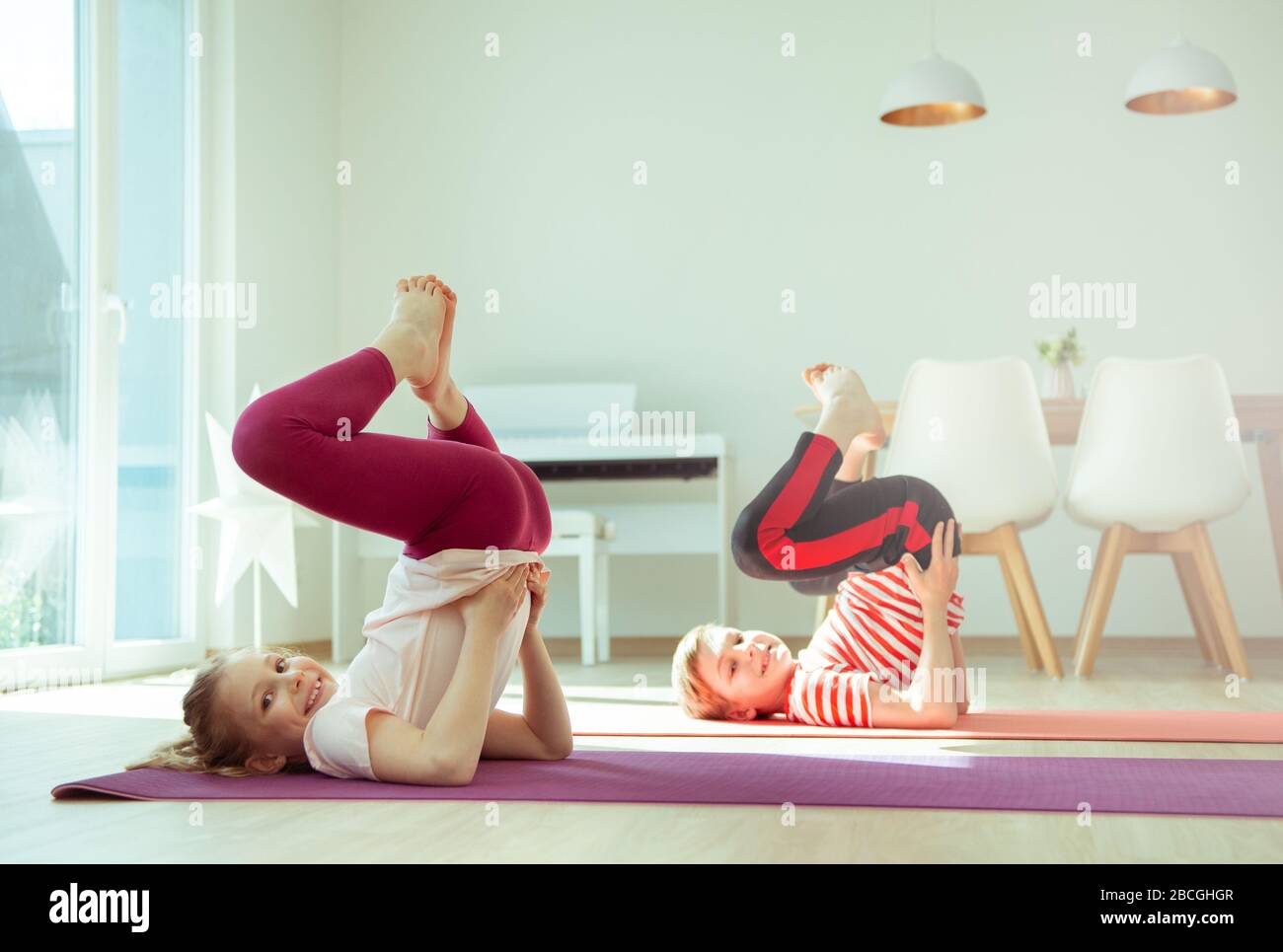 Happy siblings children making yoga at home dueing coronavirus ...