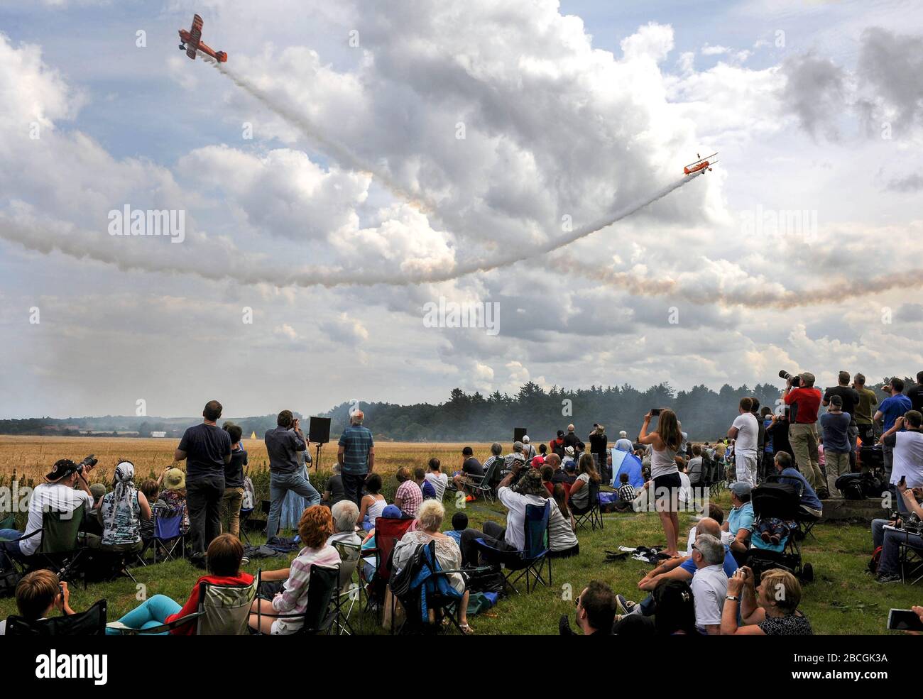 Crowds watch the Breitling Wingwalkers aerobatic display team at the East Fortune Airshow. Stock Photo