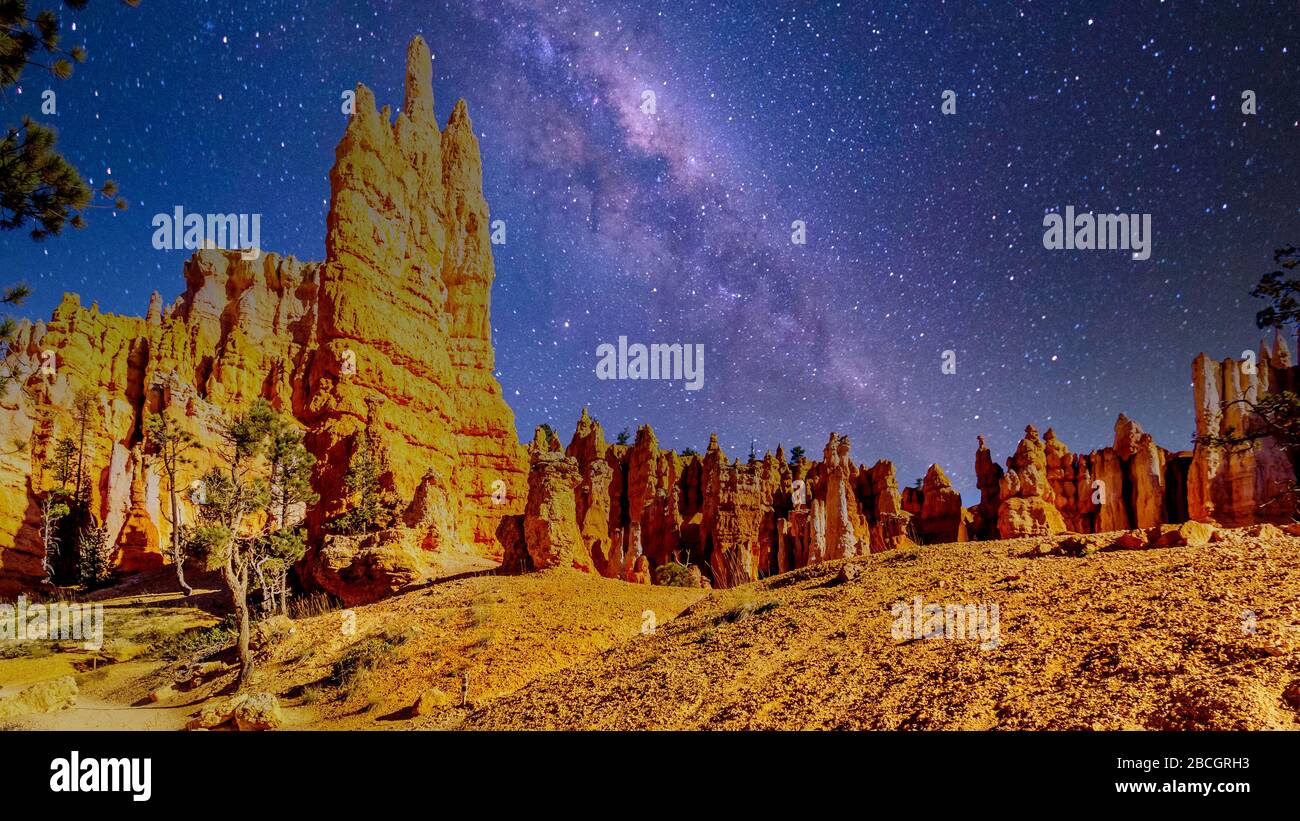 Galaxy in the night sky over the natural vermilion colored hoodoos on the Queen's Garden Trail in Bryce Canyon National Park, Utah, United States Stock Photo